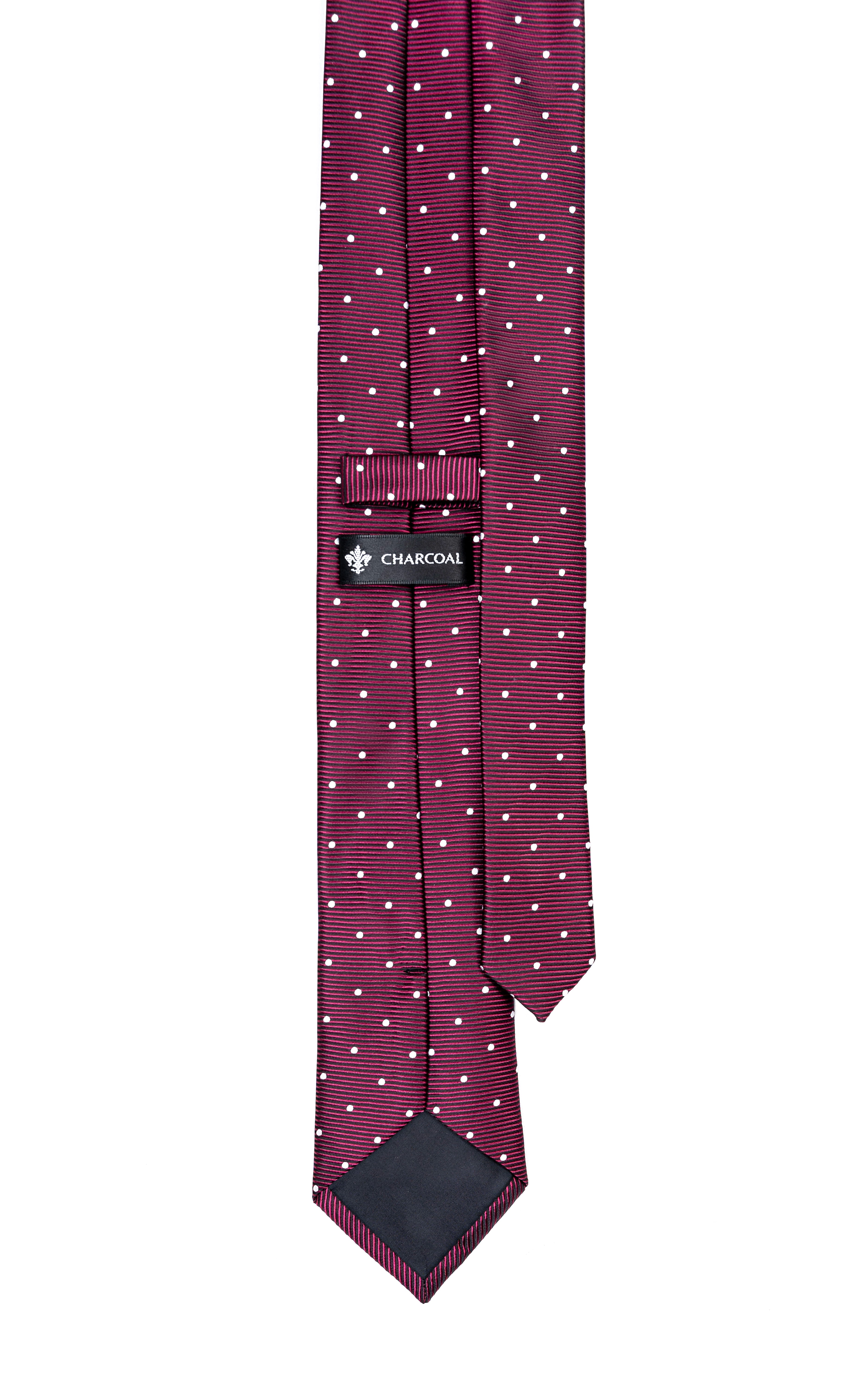 Burgundy poly silk tie with tiny white dots, folded showing hanging tip.