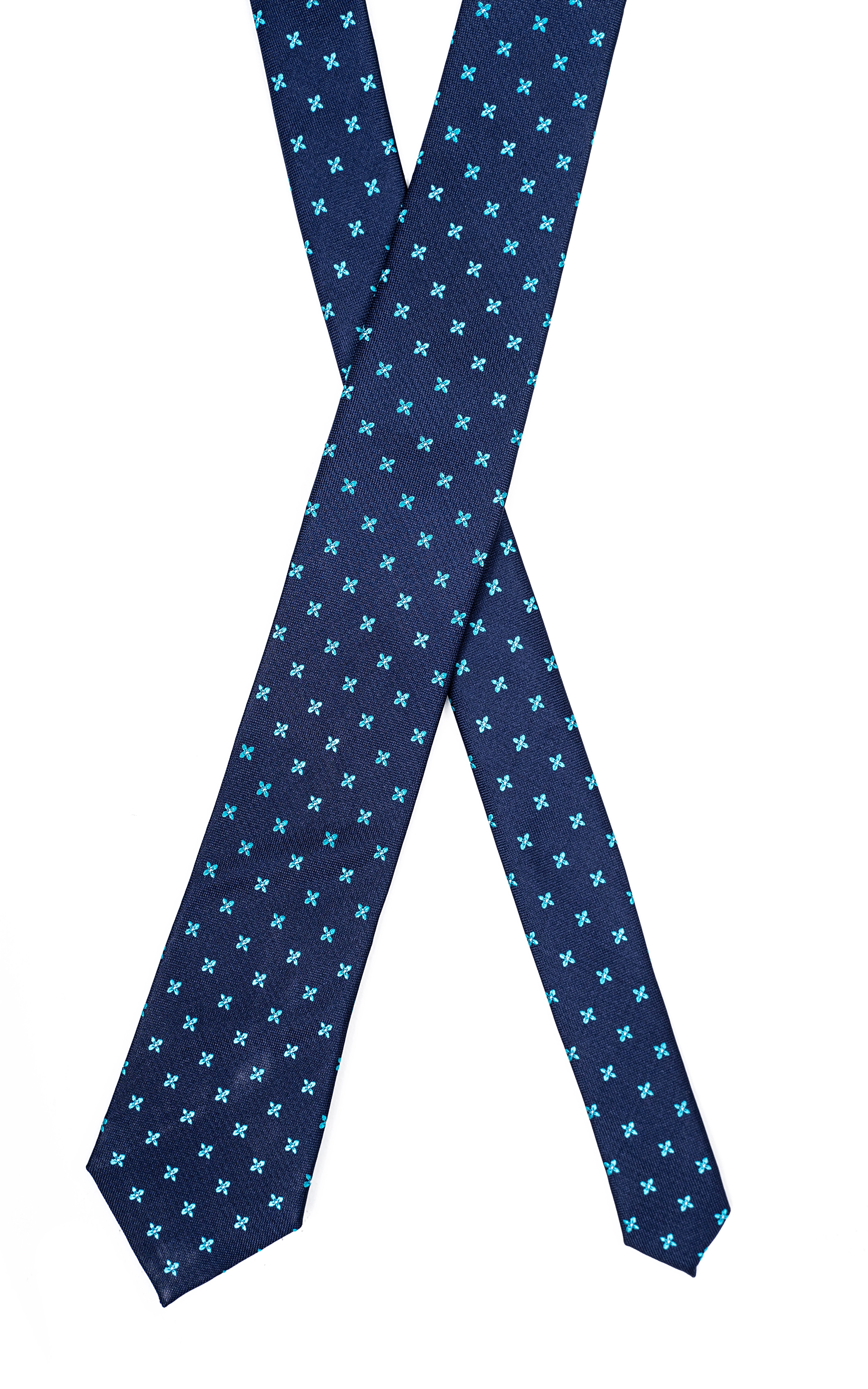 Blue polyester tie with repeating teal clover pattern, laid flat with pointed ends.