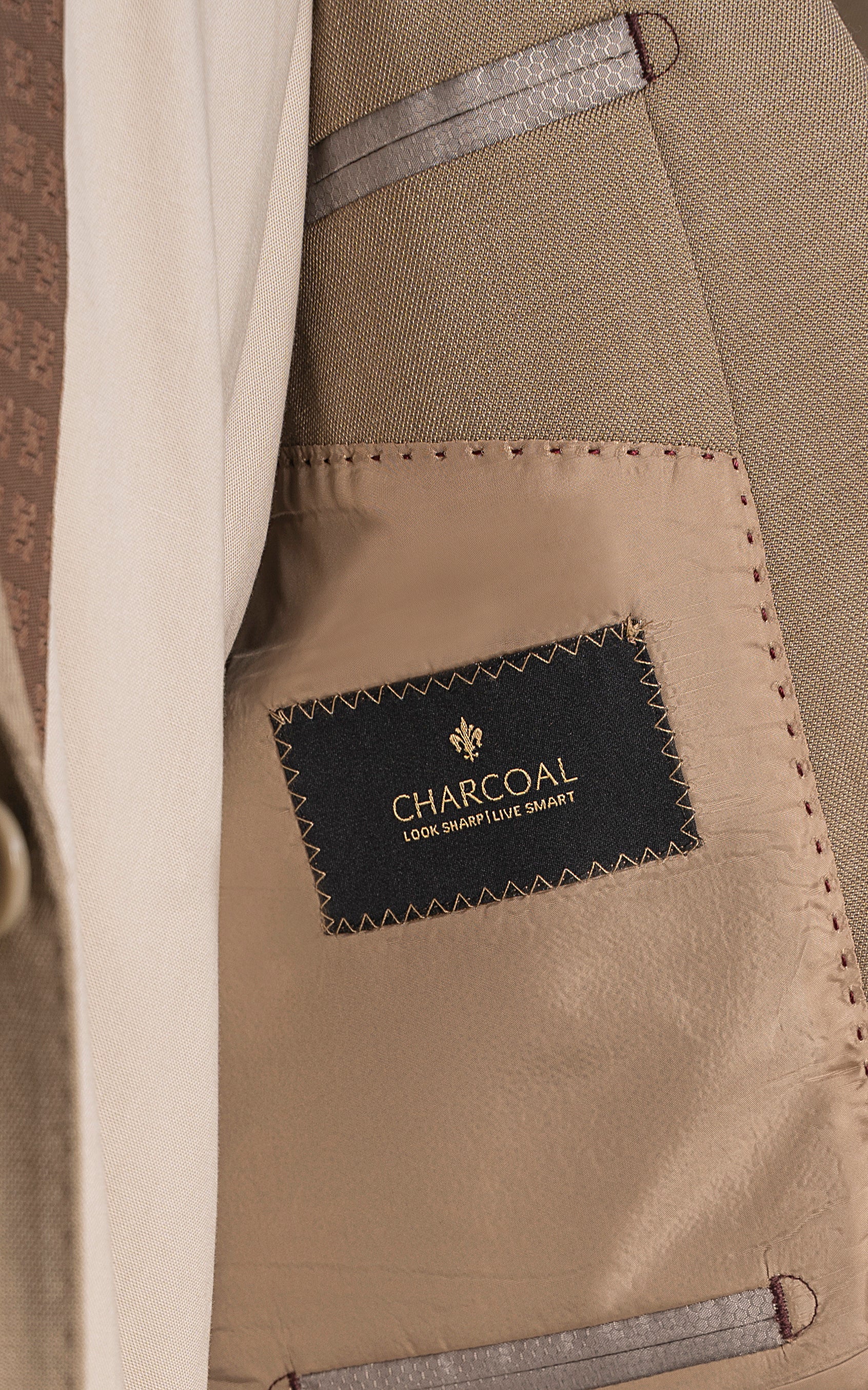 Khaki suit inner pocket with Charcoal label and stitched edge