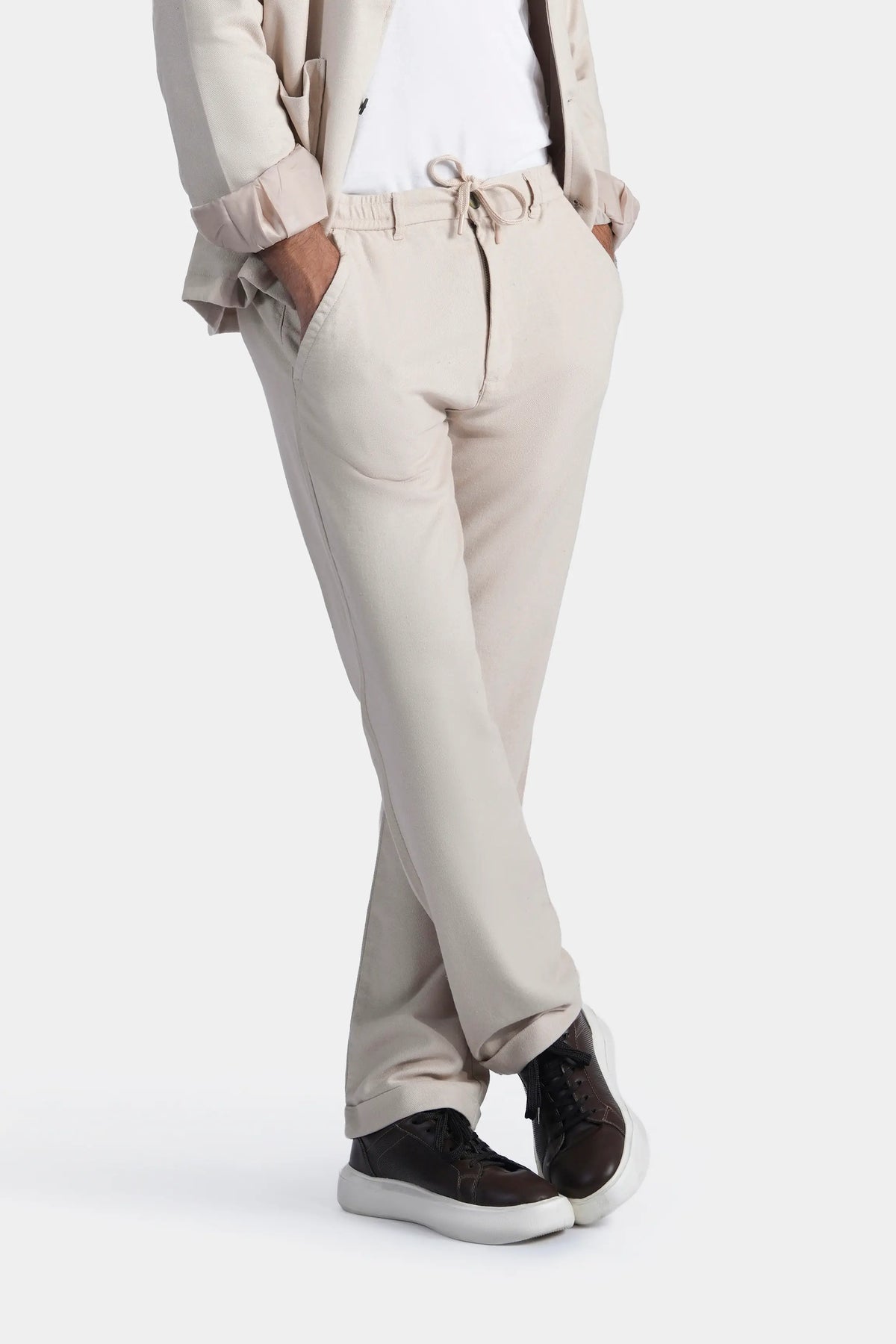 Light khaki straight trousers with drawstring waist and angled side pockets