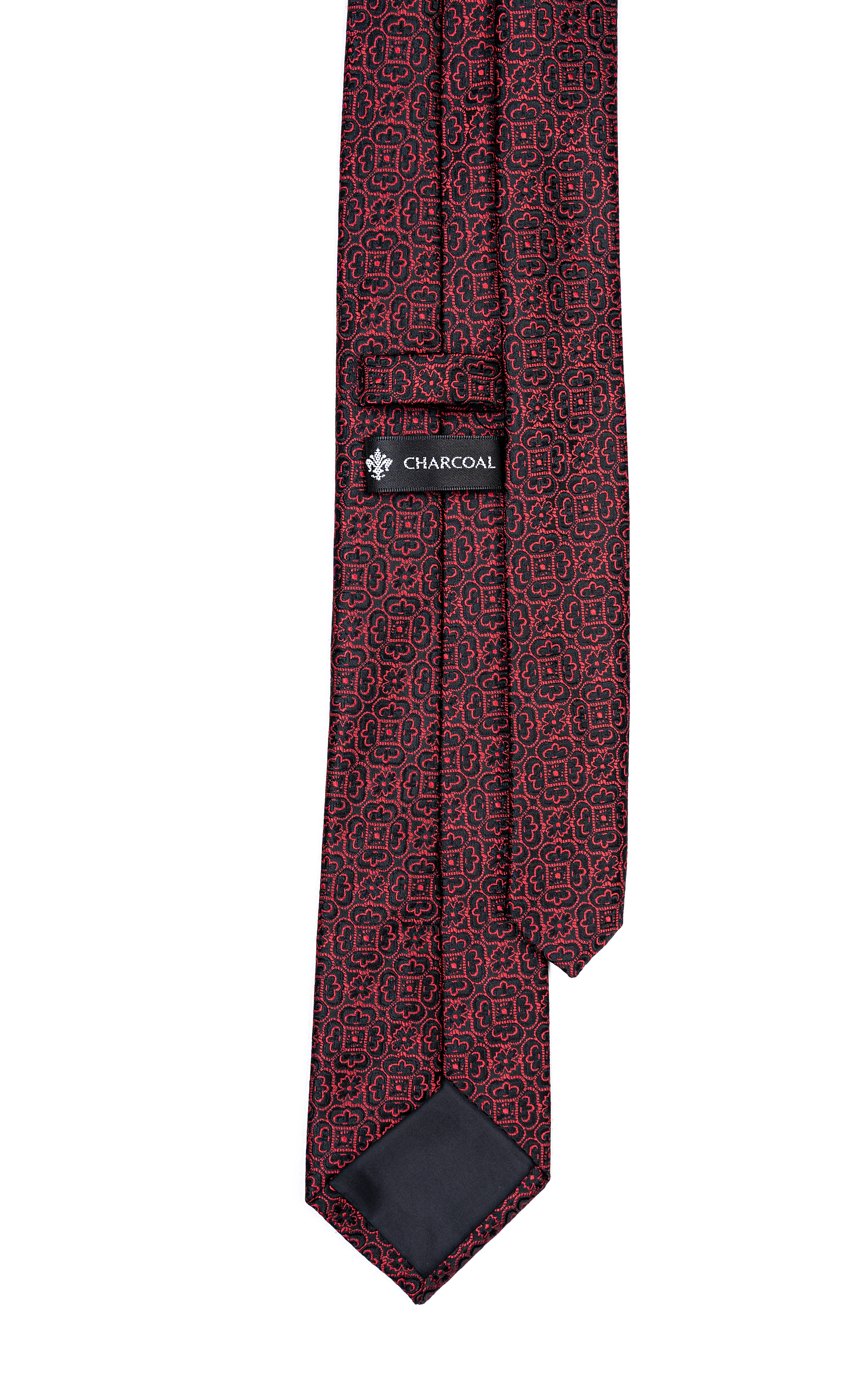 Burgundy patterned poly silk tie with dark label at keeper and pointed end