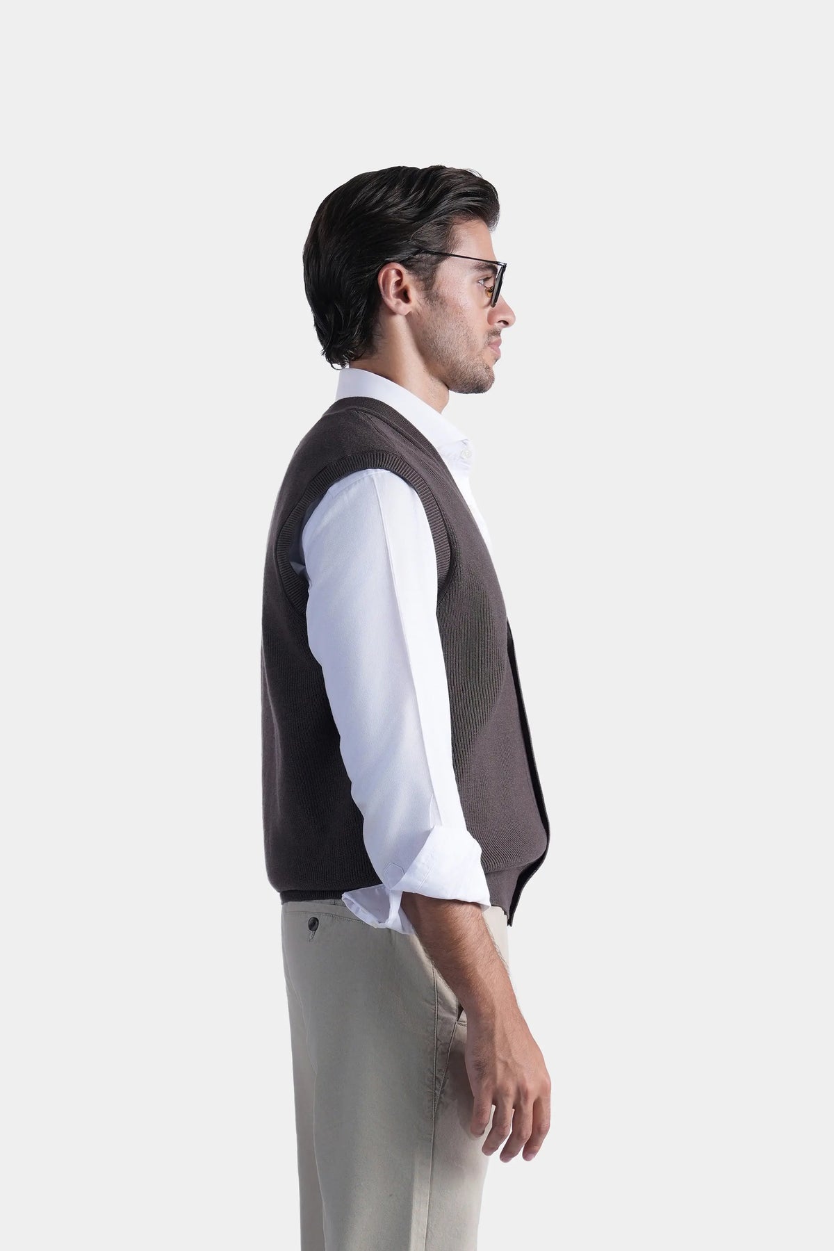 Brown V-neck sleeveless knit sweater vest in profile with button front