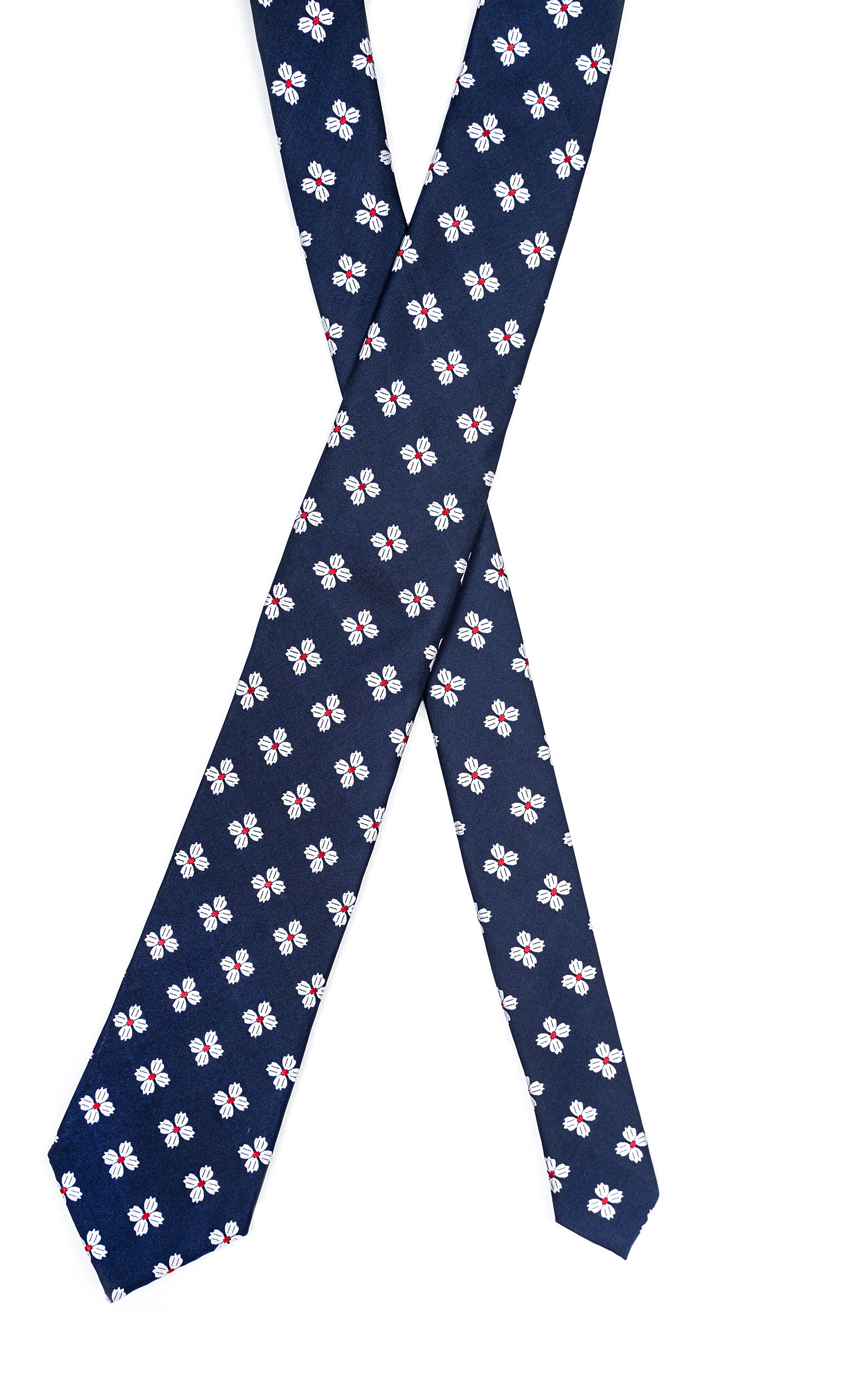 Navy poly silk tie with repeating white and pink floral motif, laid flat