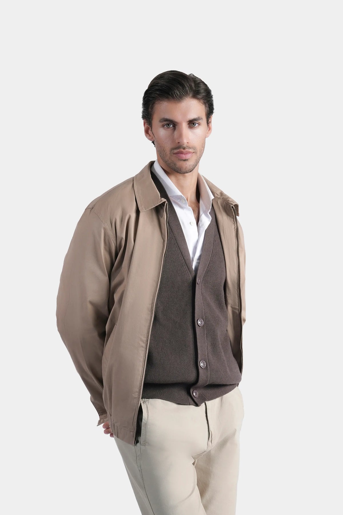 Khaki relaxed-fit jacket with stand collar and snap buttons over knit top