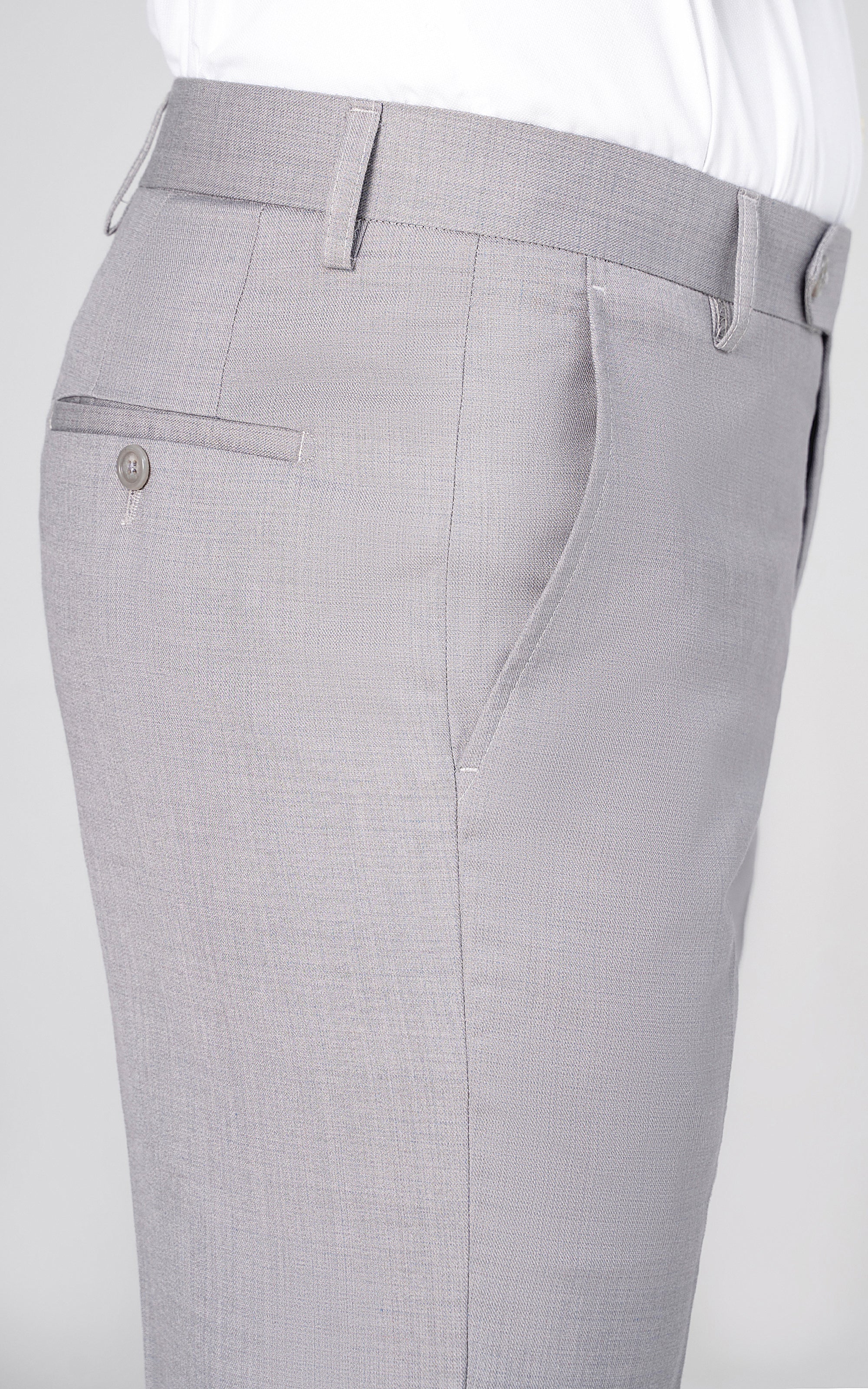 Light grey dress pants close-up of waistband, belt loops, and front pocket