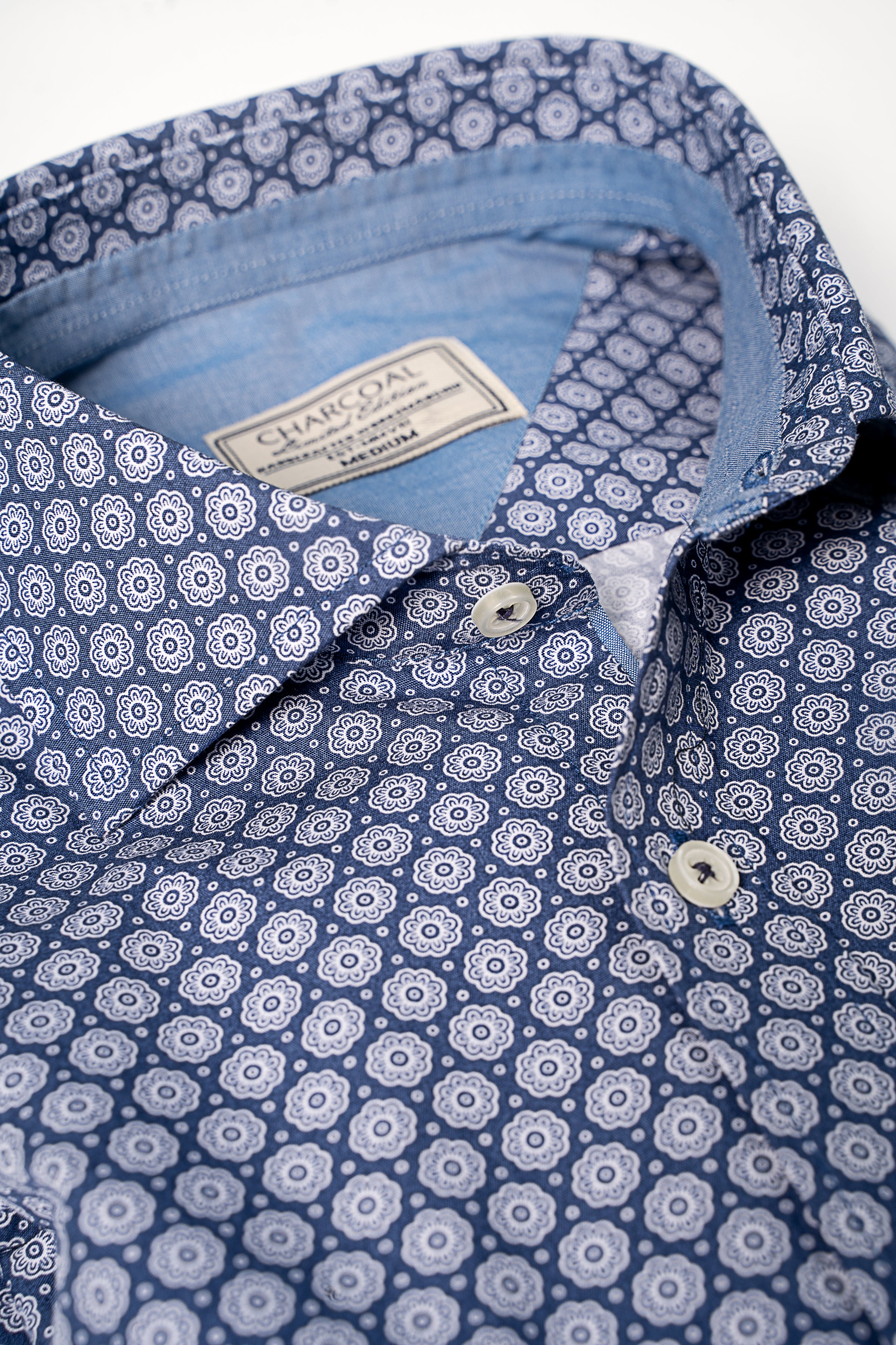 Navy printed dress shirt with folded collar and white button placket detail