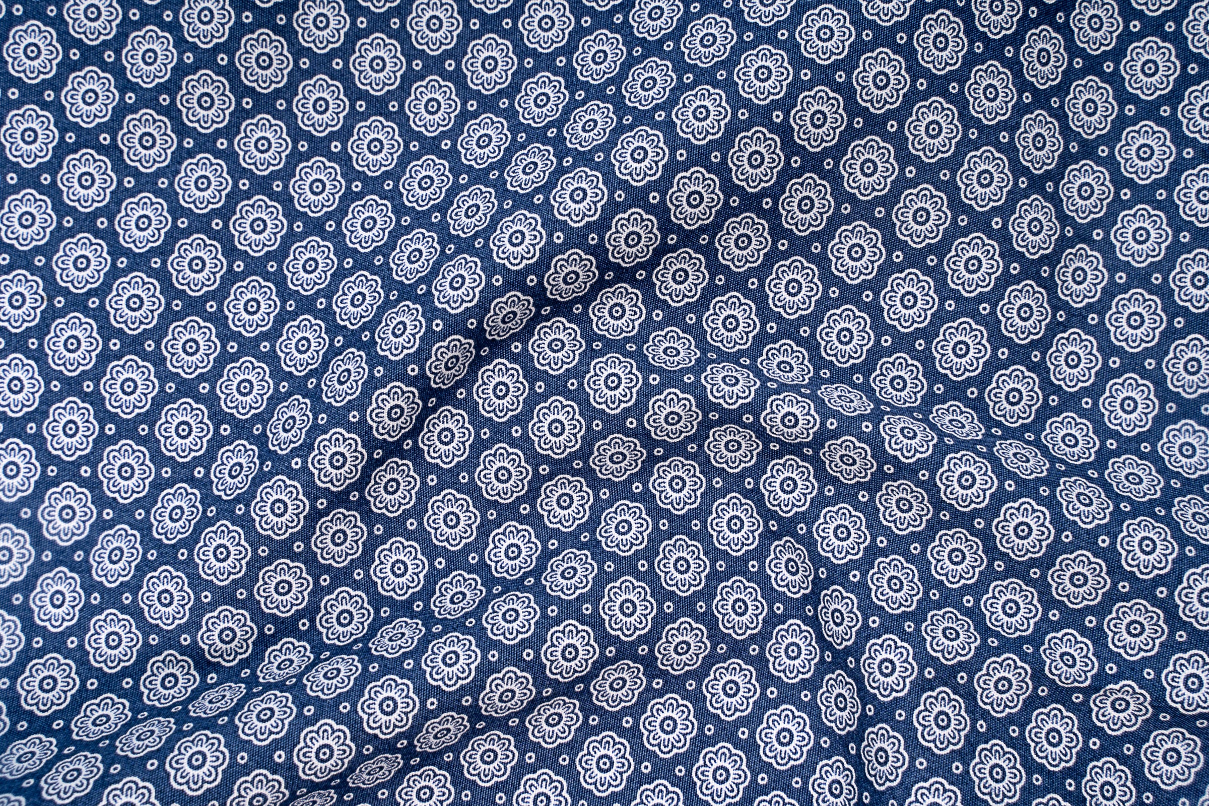 Navy printed dress shirt fabric with repeating white floral pattern