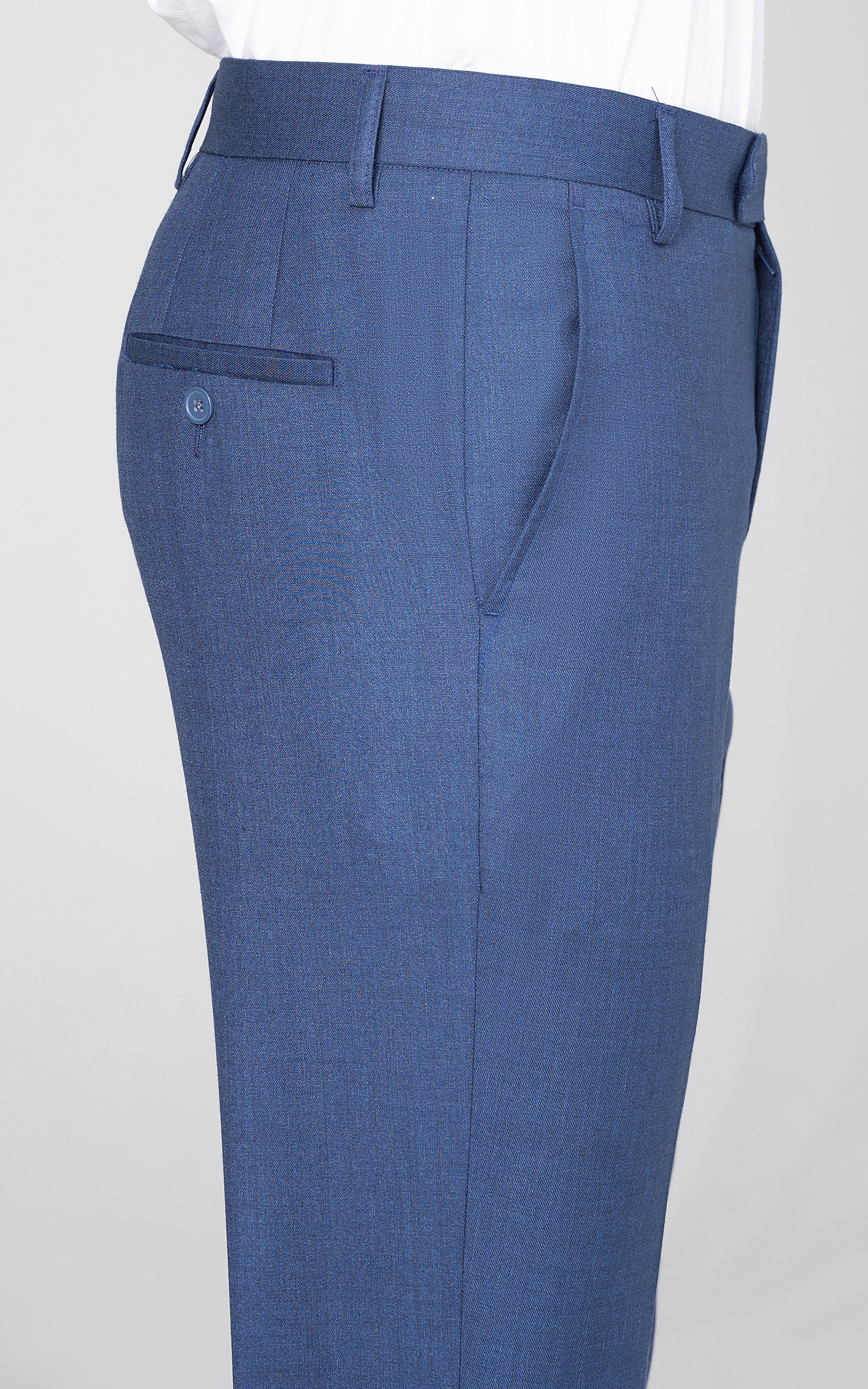 Blue dress pants pocket and waistband detail with button closure