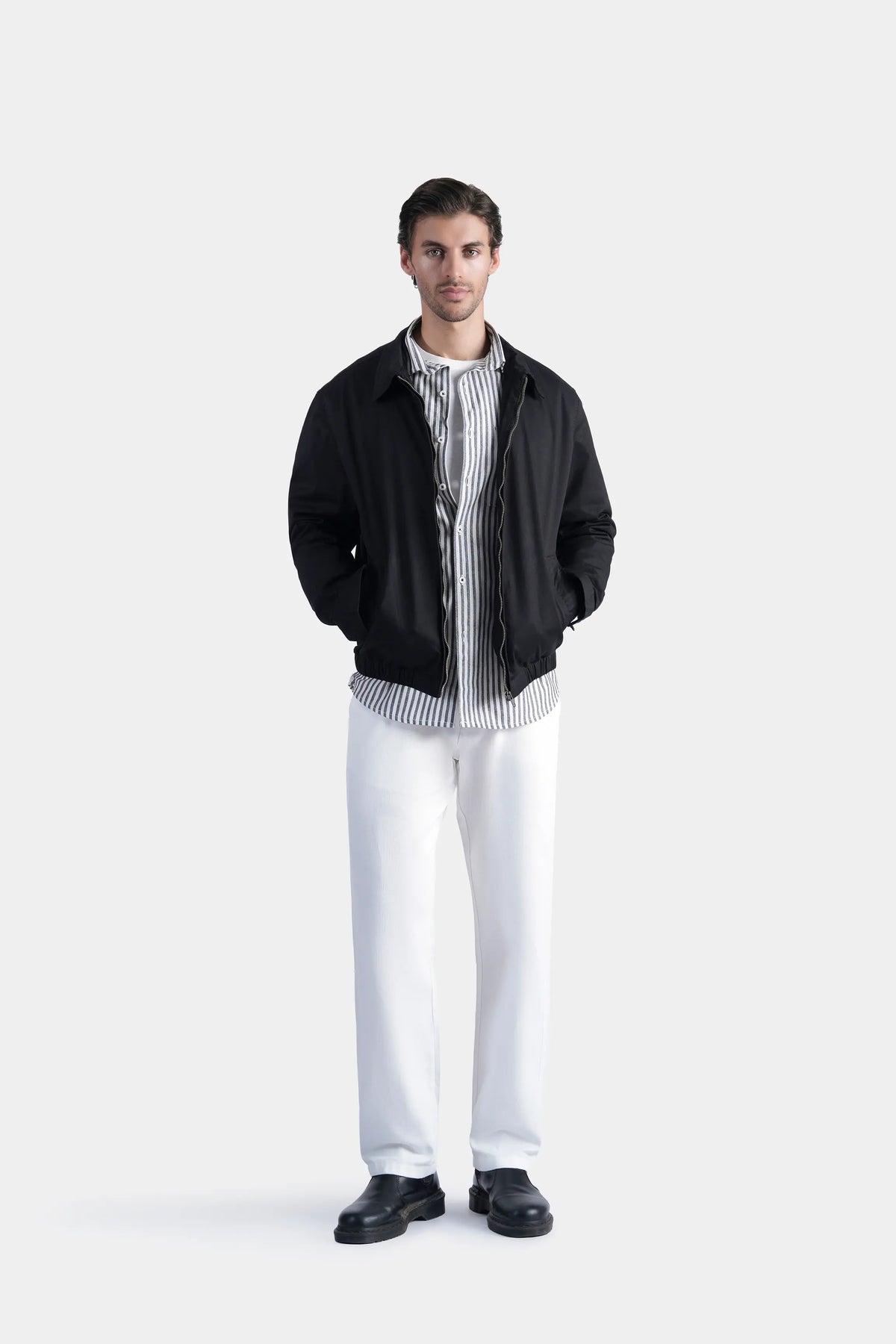 Black relaxed-fit full-sleeve jacket with zip front and stand collar, ribbed cuffs