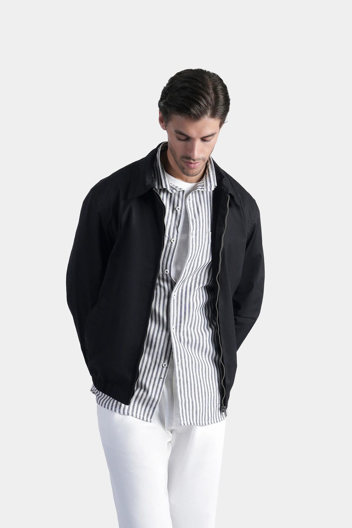 Black relaxed-fit jacket worn open, stand collar and zip front with ribbed hem