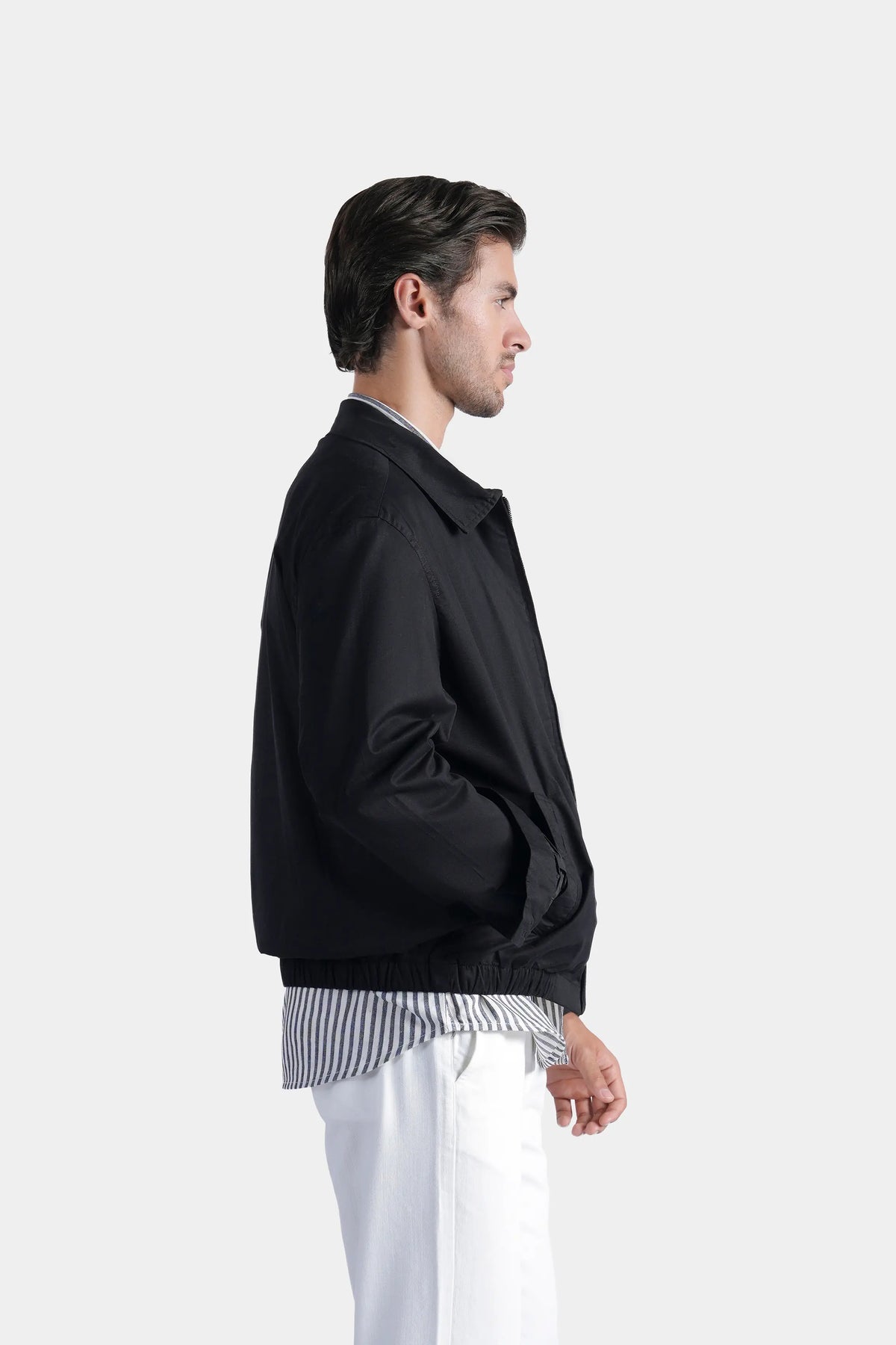 Black relaxed-fit jacket side view, stand collar and ribbed cuff detail
