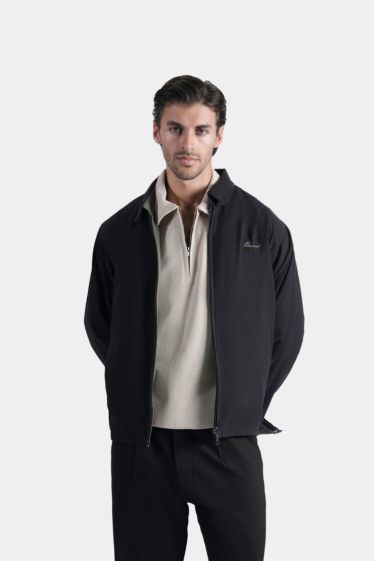 Black reversible collar jacket with zipper front and flap pockets, olive-lined edges