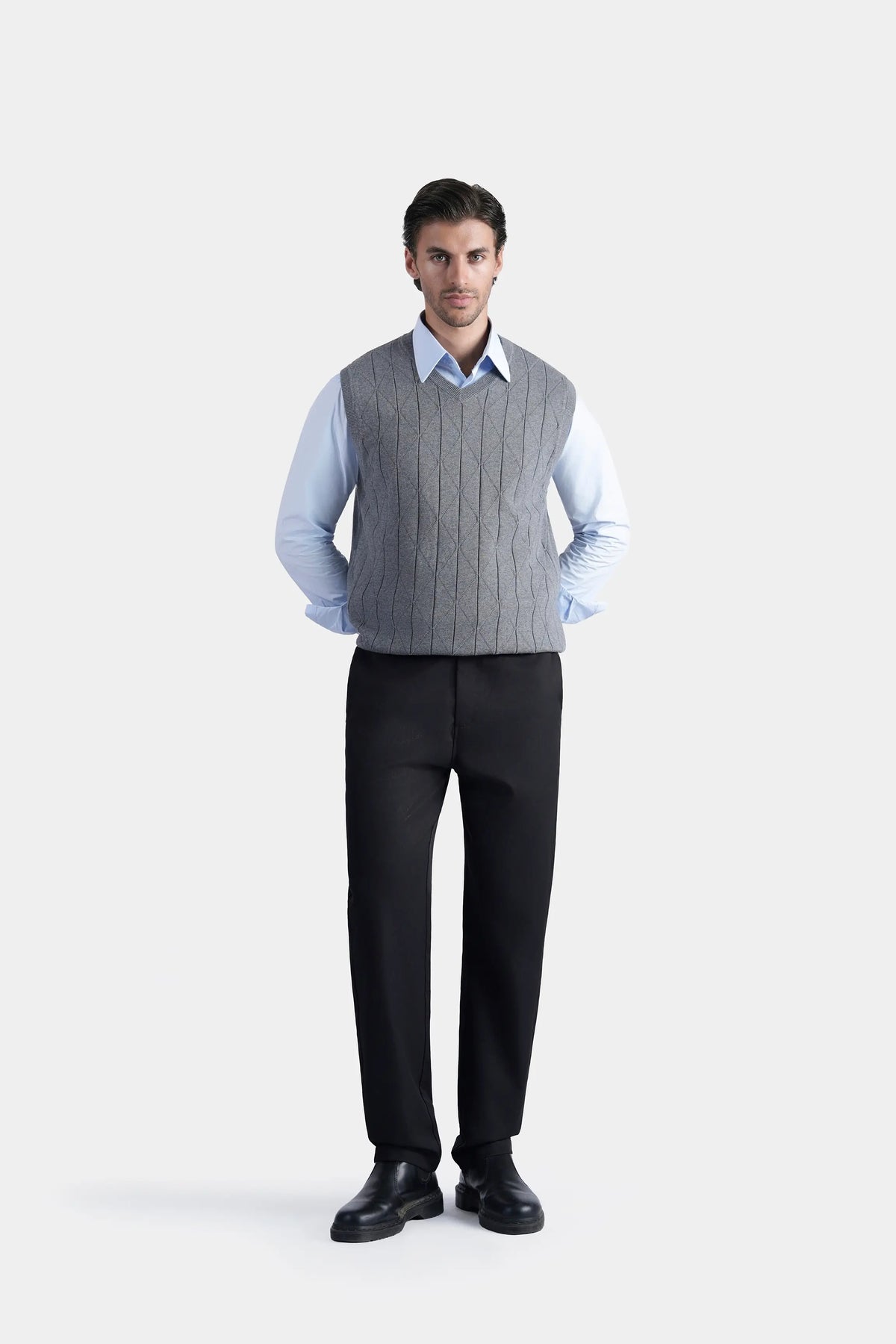 Grey sleeveless knitted V-neck sweater vest with ribbed trim and textured knit pattern