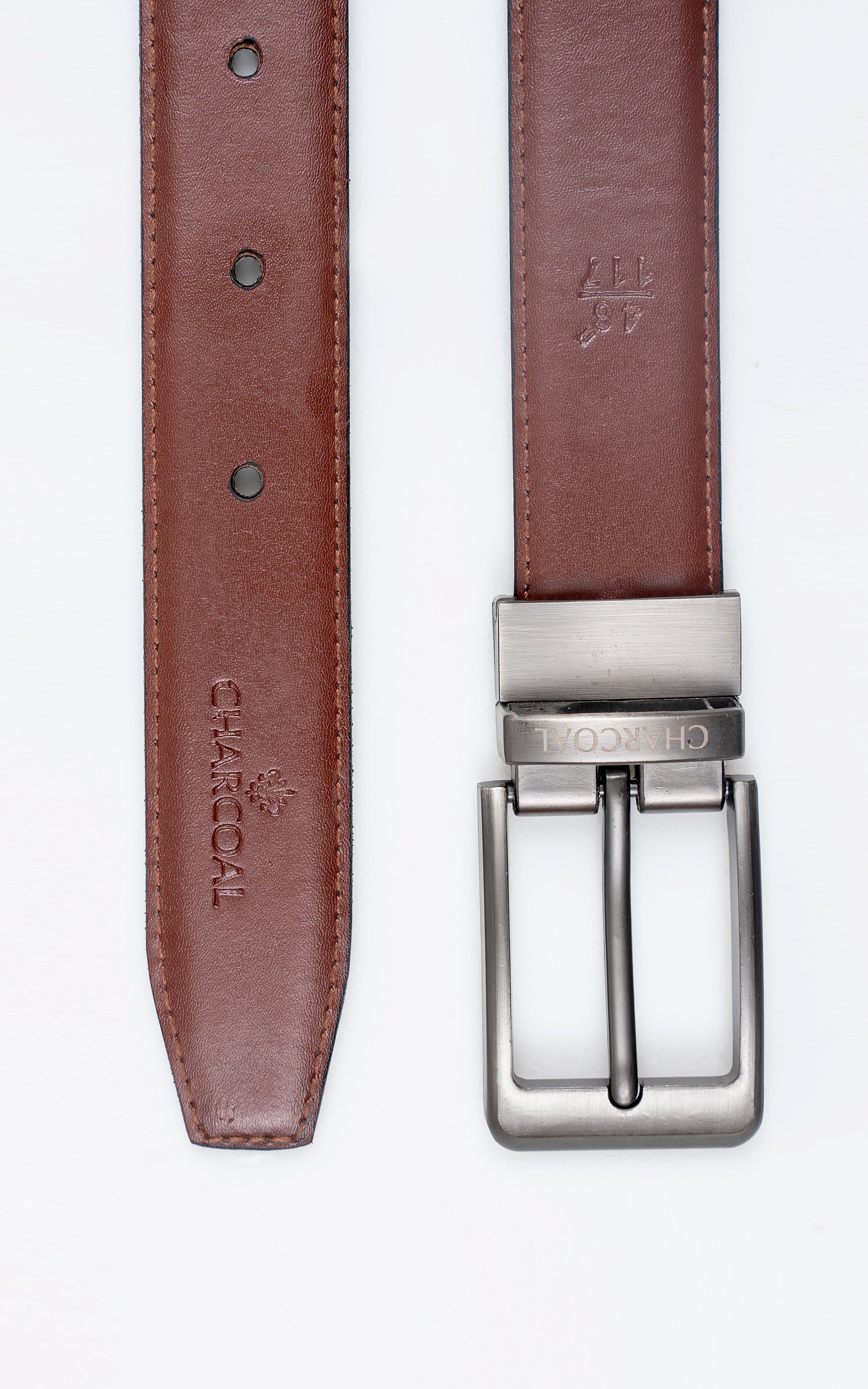 Brown leather belt strap detail with punched holes and silver-tone buckle