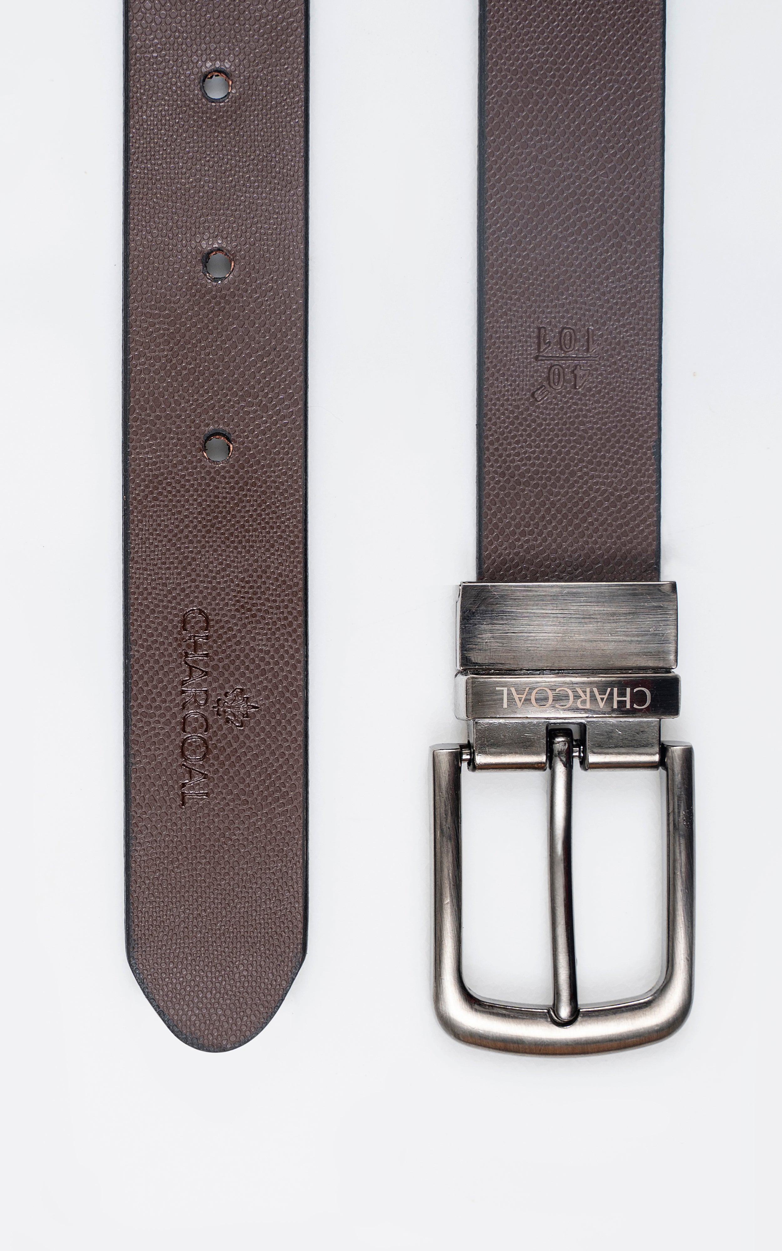 Reversible leather belt buckle on brown side; textured strap with three button holes.