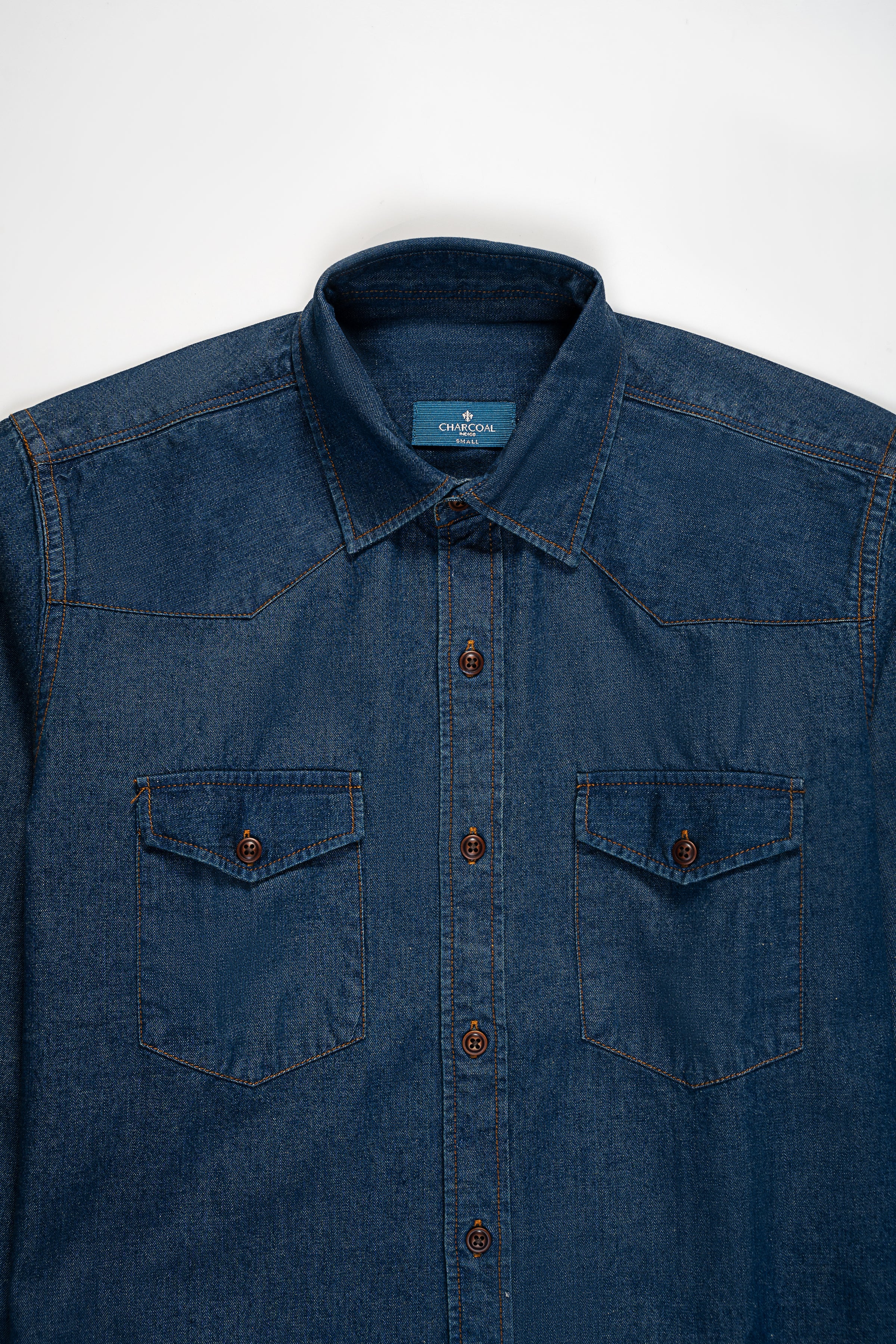 Blue denim button-up shirt with two front chest pockets and button placket