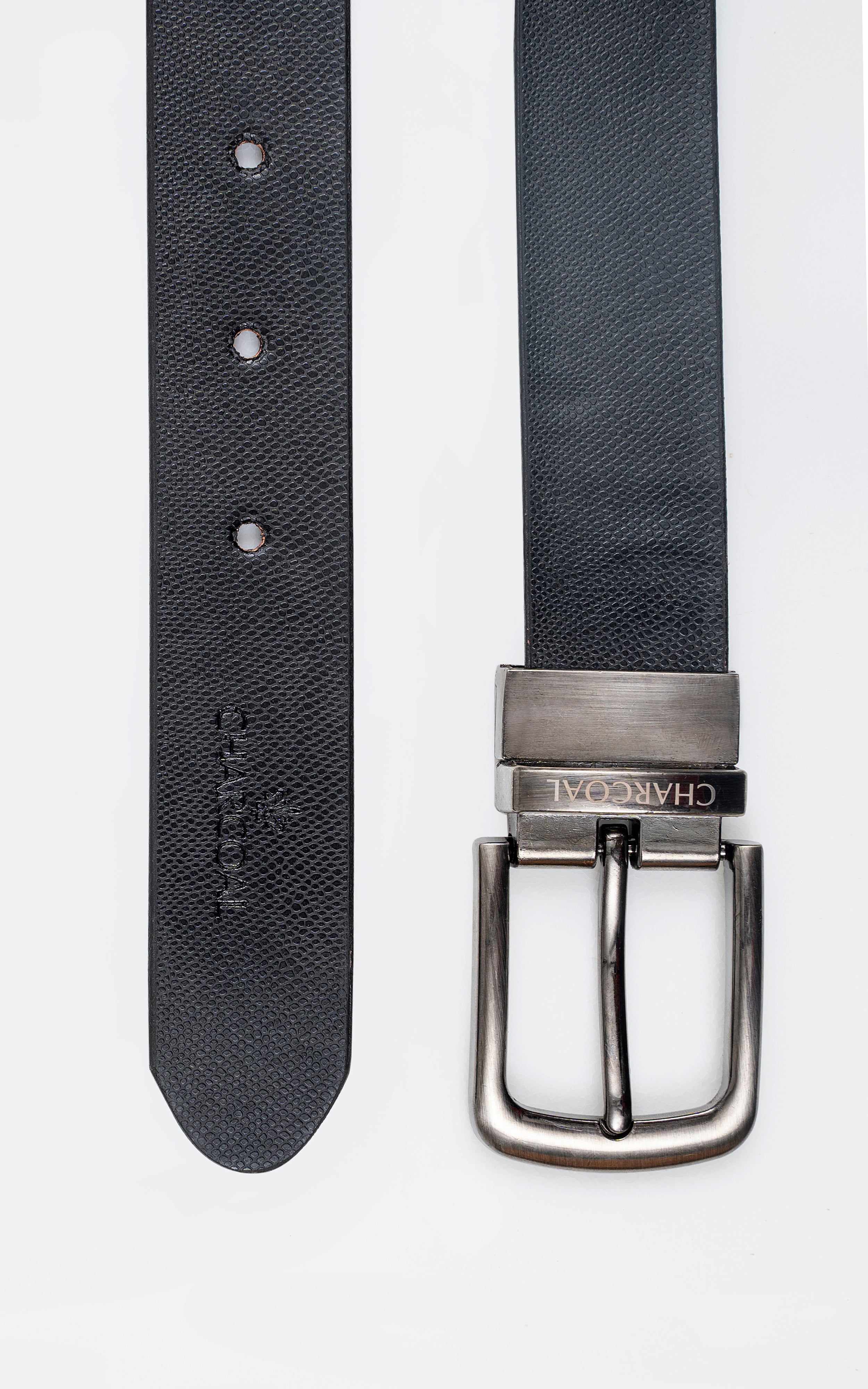 Reversible leather belt with textured dark side; silver buckle and three button holes.