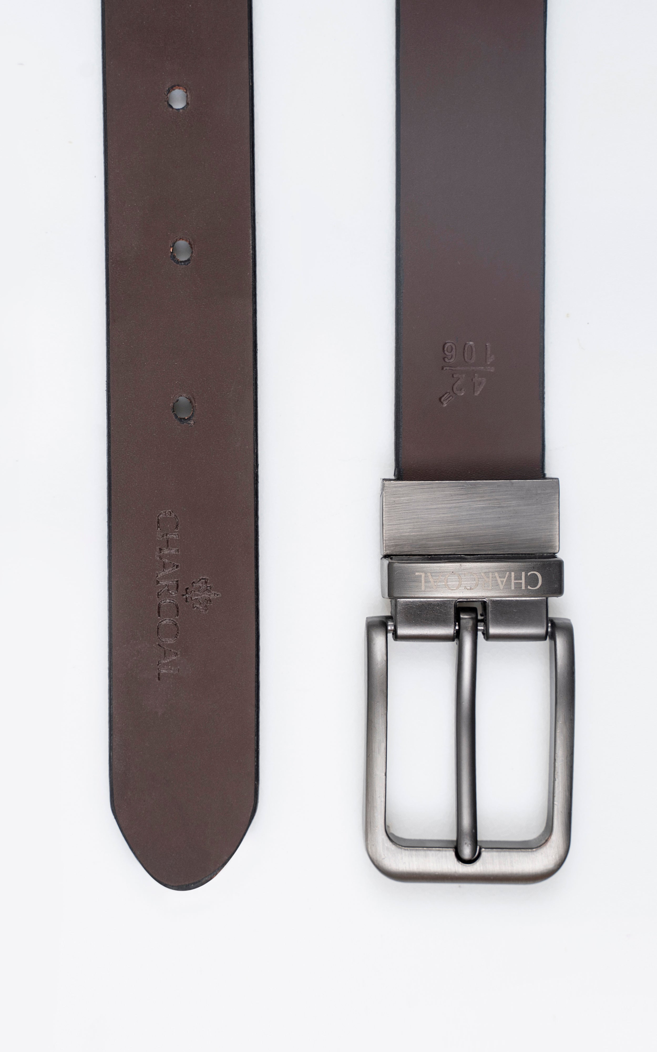 Reversible belt with dark brown strap, metal buckle, and visible belt holes
