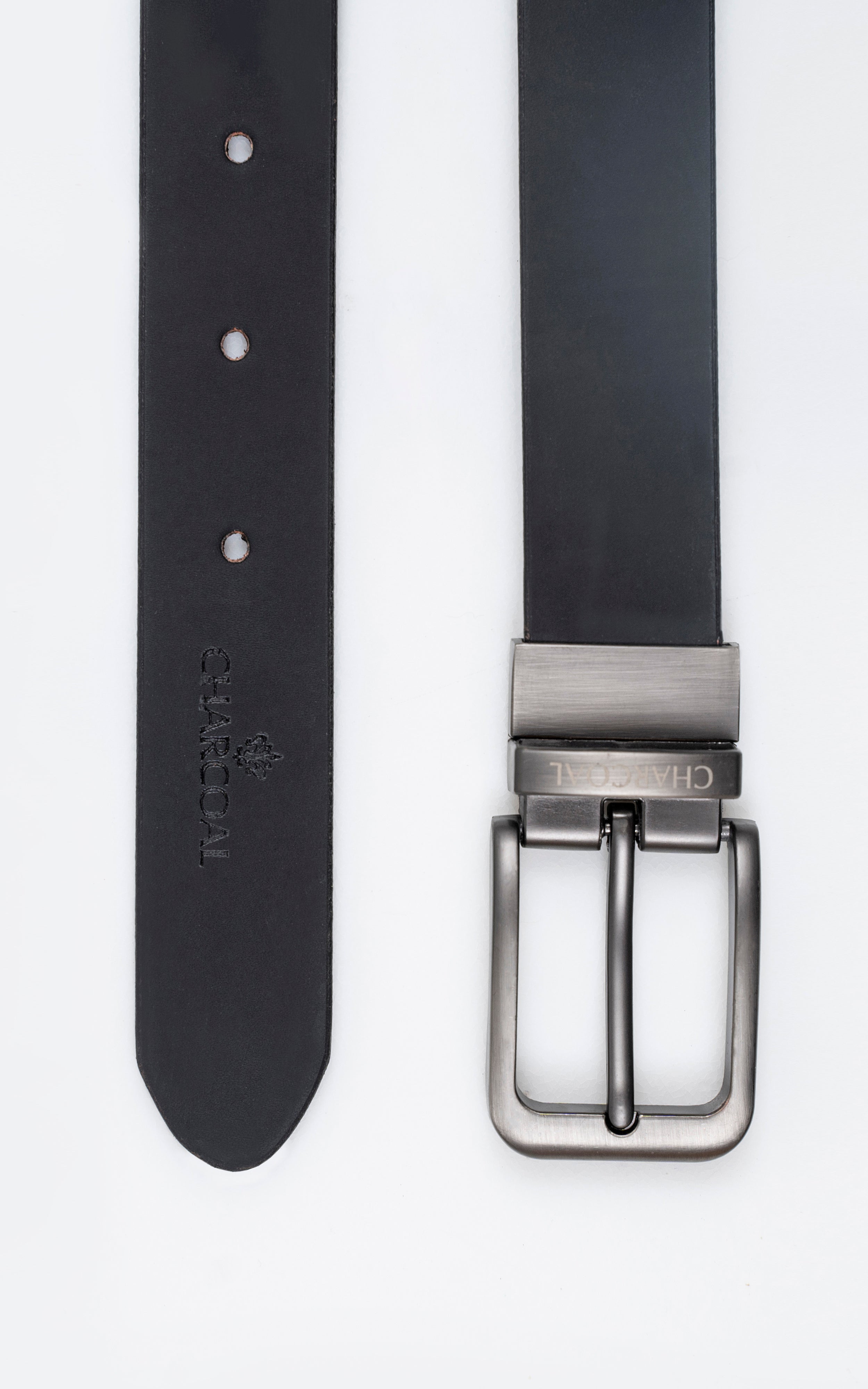 Reversible belt with dark strap, metal buckle, and visible belt holes