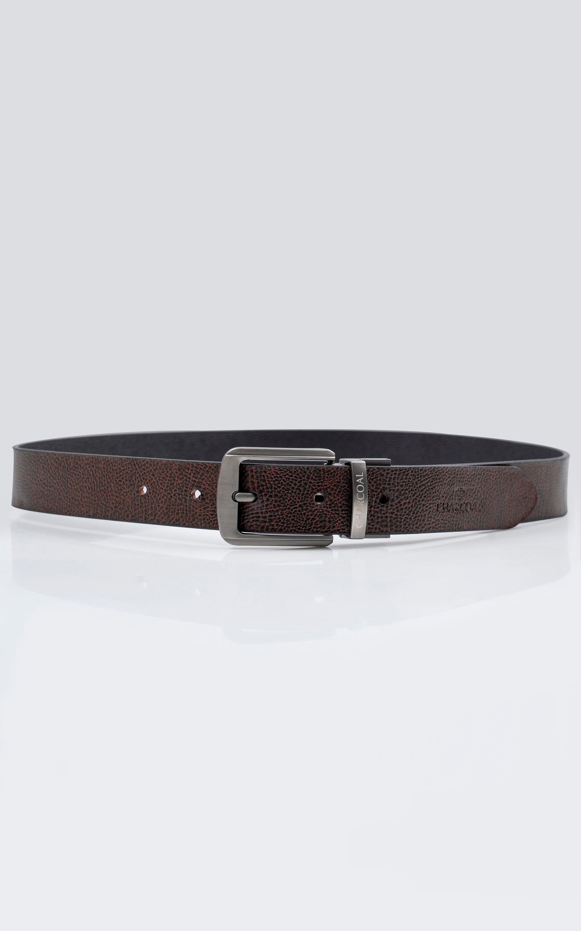 Reversible belt showing brown inner side, black edge, and silver buckle.