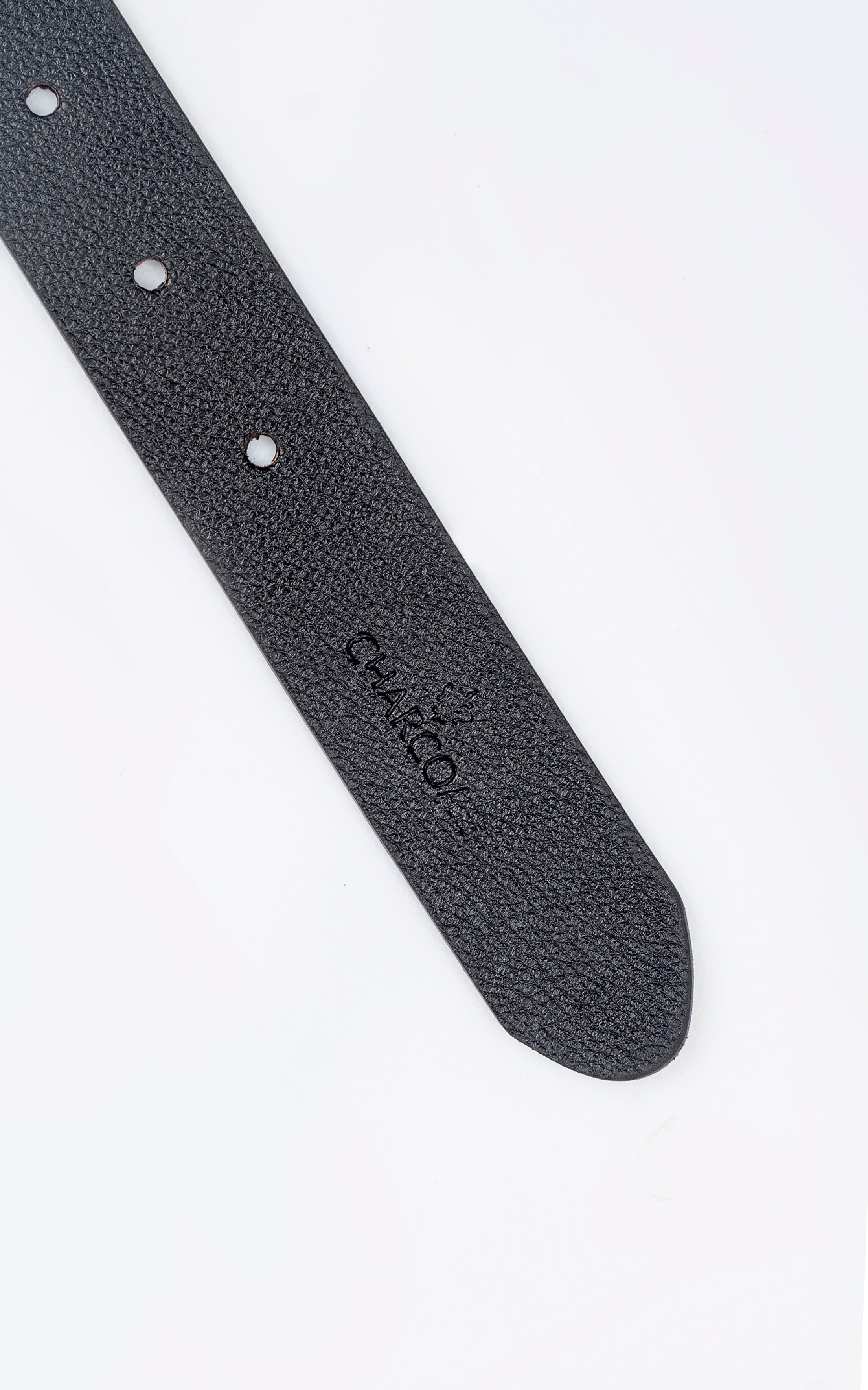 Reversible belt end with black textured strap and stitched edge, hole marks.