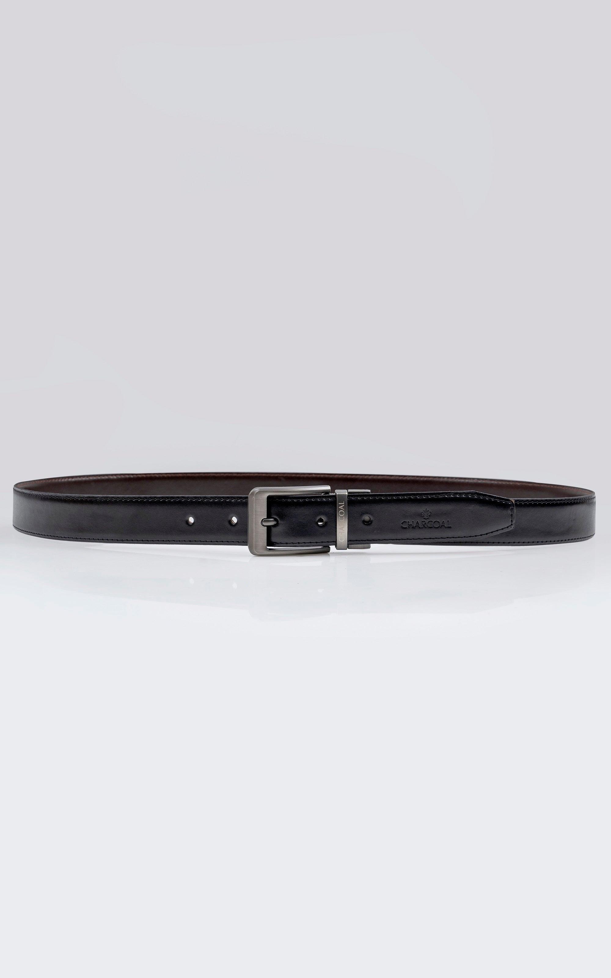 Reversible leather belt with rectangular silver buckle, dark strap and punched holes