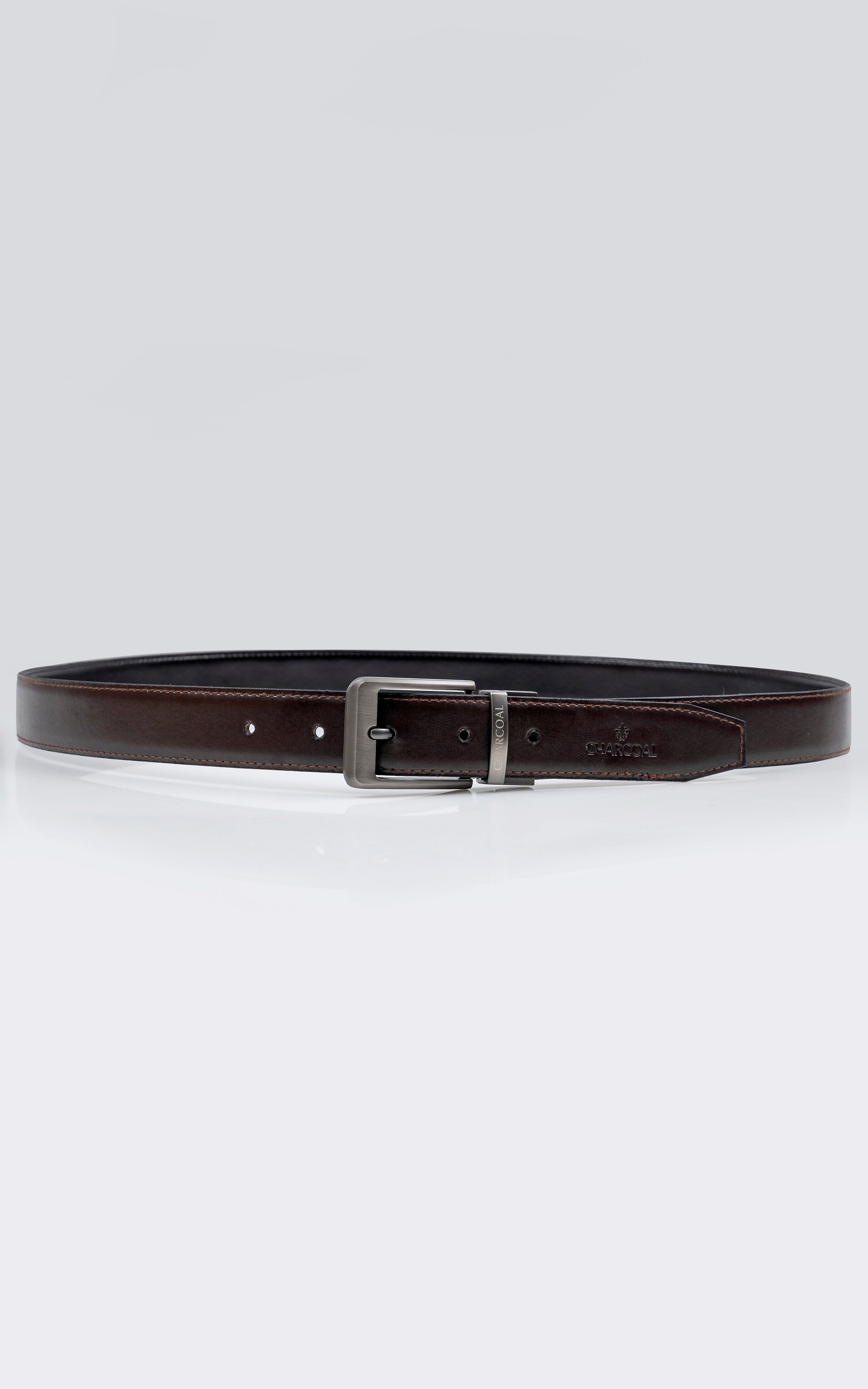 Reversible leather belt with silver buckle, dark front and brown reverse strap