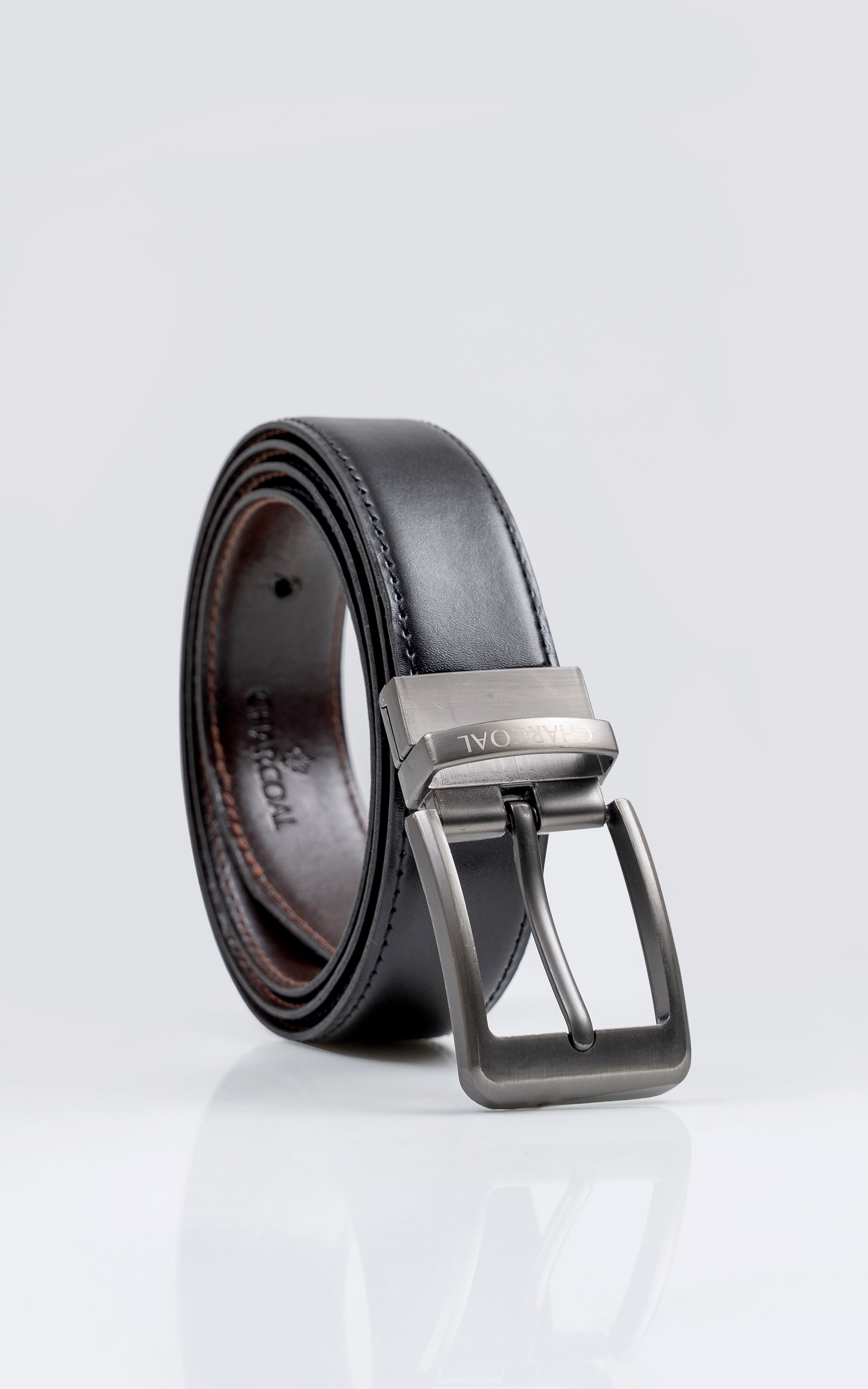 Reversible leather belt with silver buckle, dark strap shown in side view