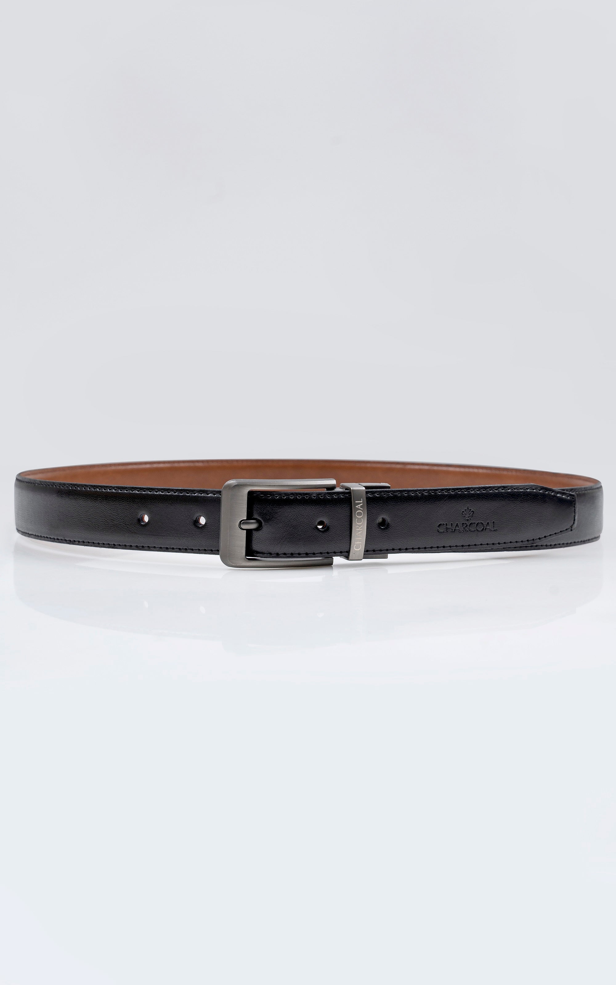 Reversible leather belt with black edge and brown underside, silver buckle.