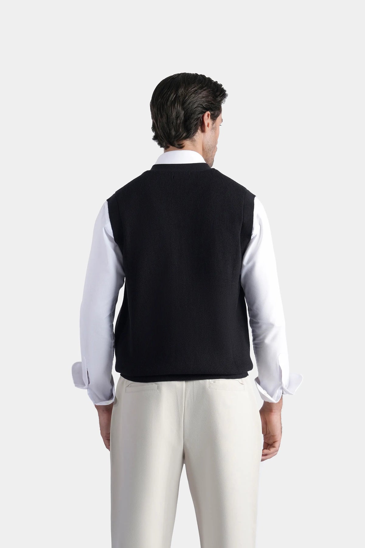 Black V-neck sleeveless knit sweater vest with button front, back view