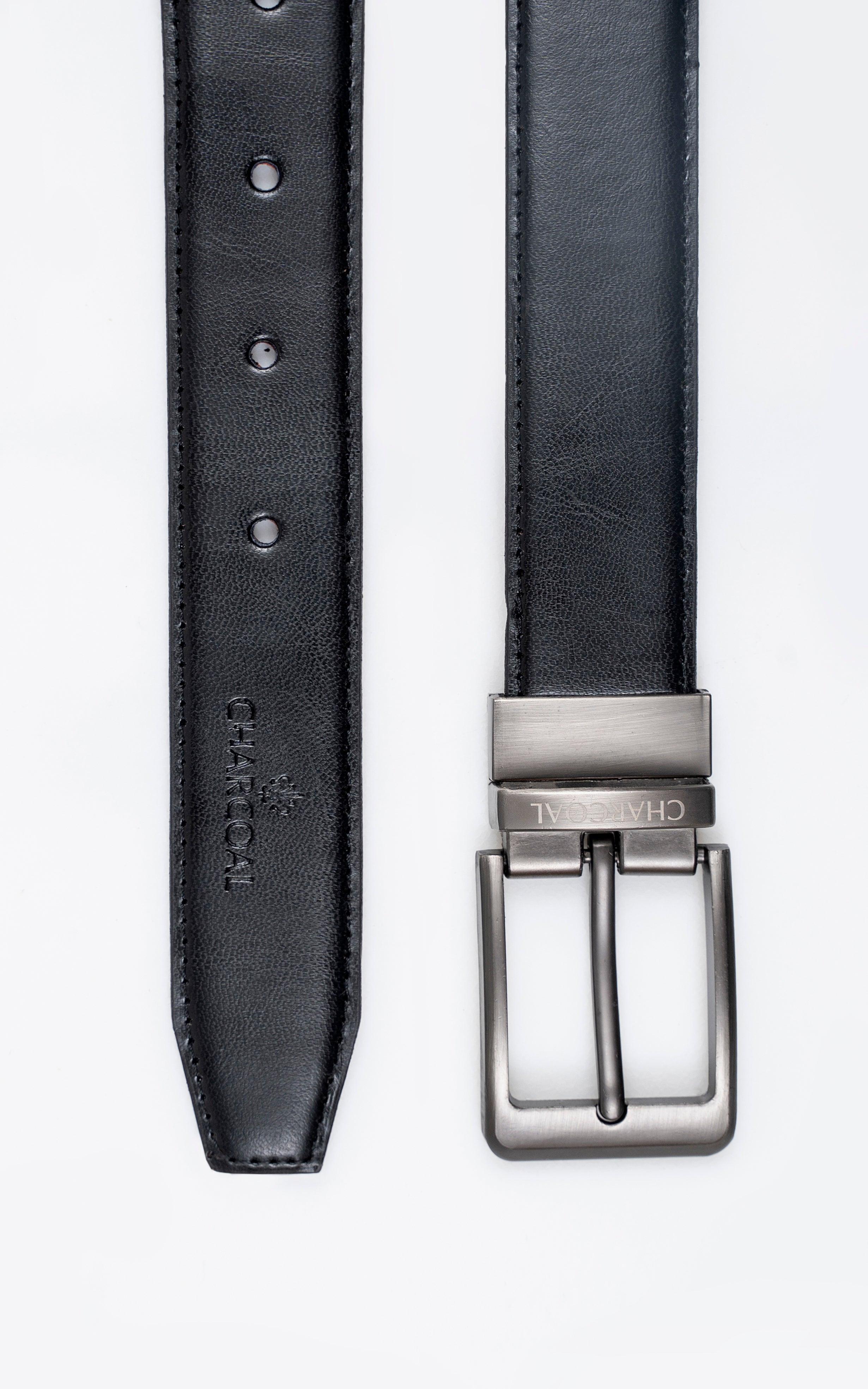 Black leather belt strap detail with metal buckle and punched hole tabs.