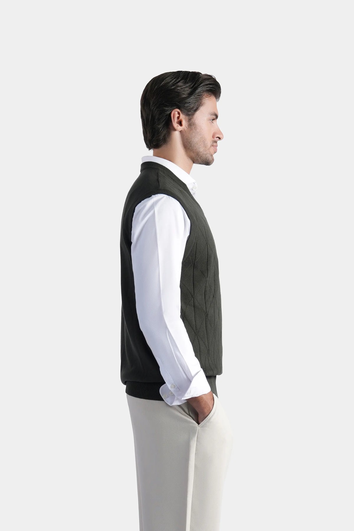 Sleeveless knit V-neck sweater vest in dark color, side view with ribbed hem