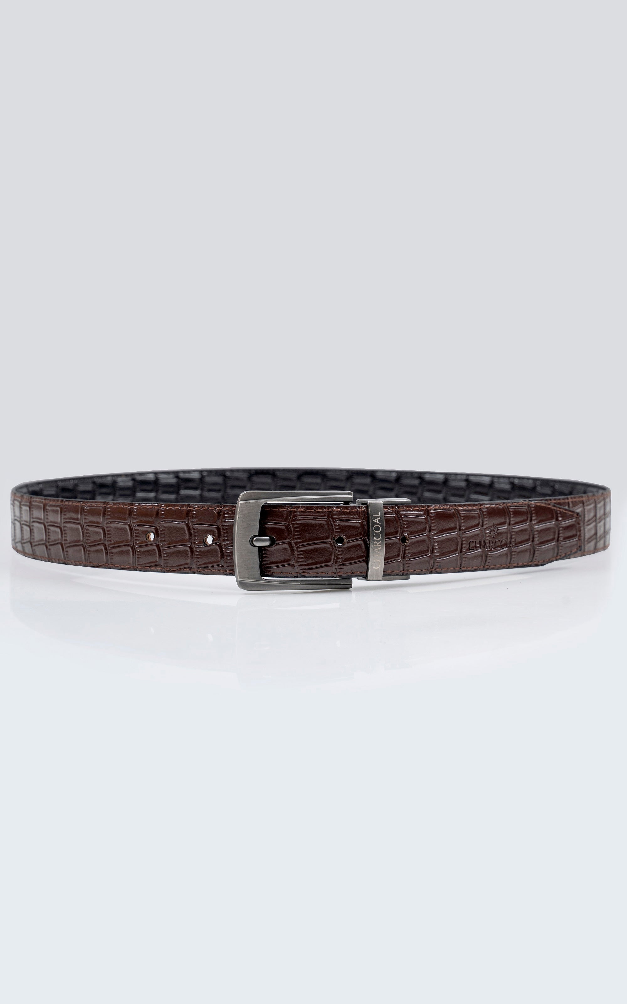 Reversible leather belt with brown crocodile texture and square metal buckle.