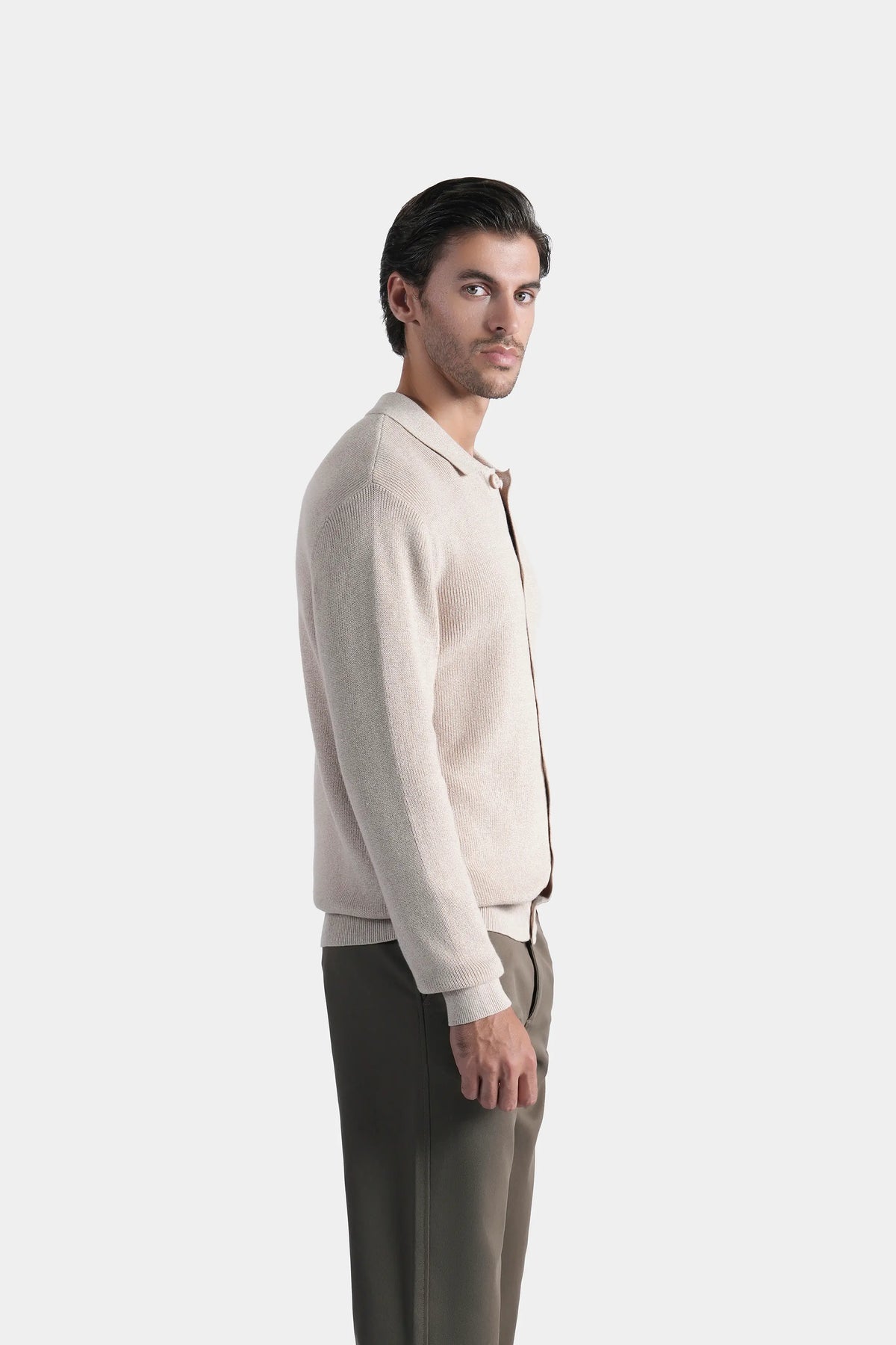 Beige knitted long-sleeve cardigan with button front, side profile view