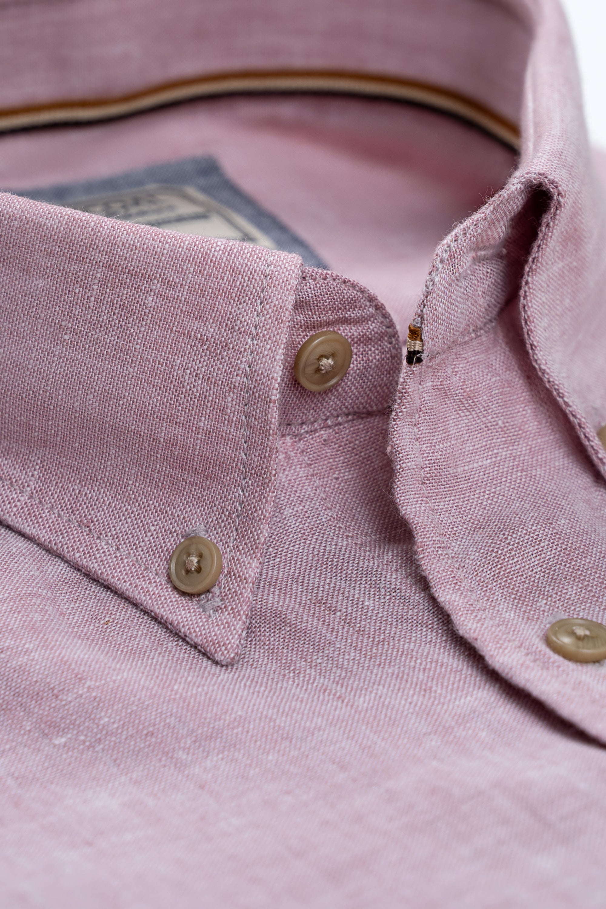 Coral pink linen shirt detail: button placket and pointed collar tips