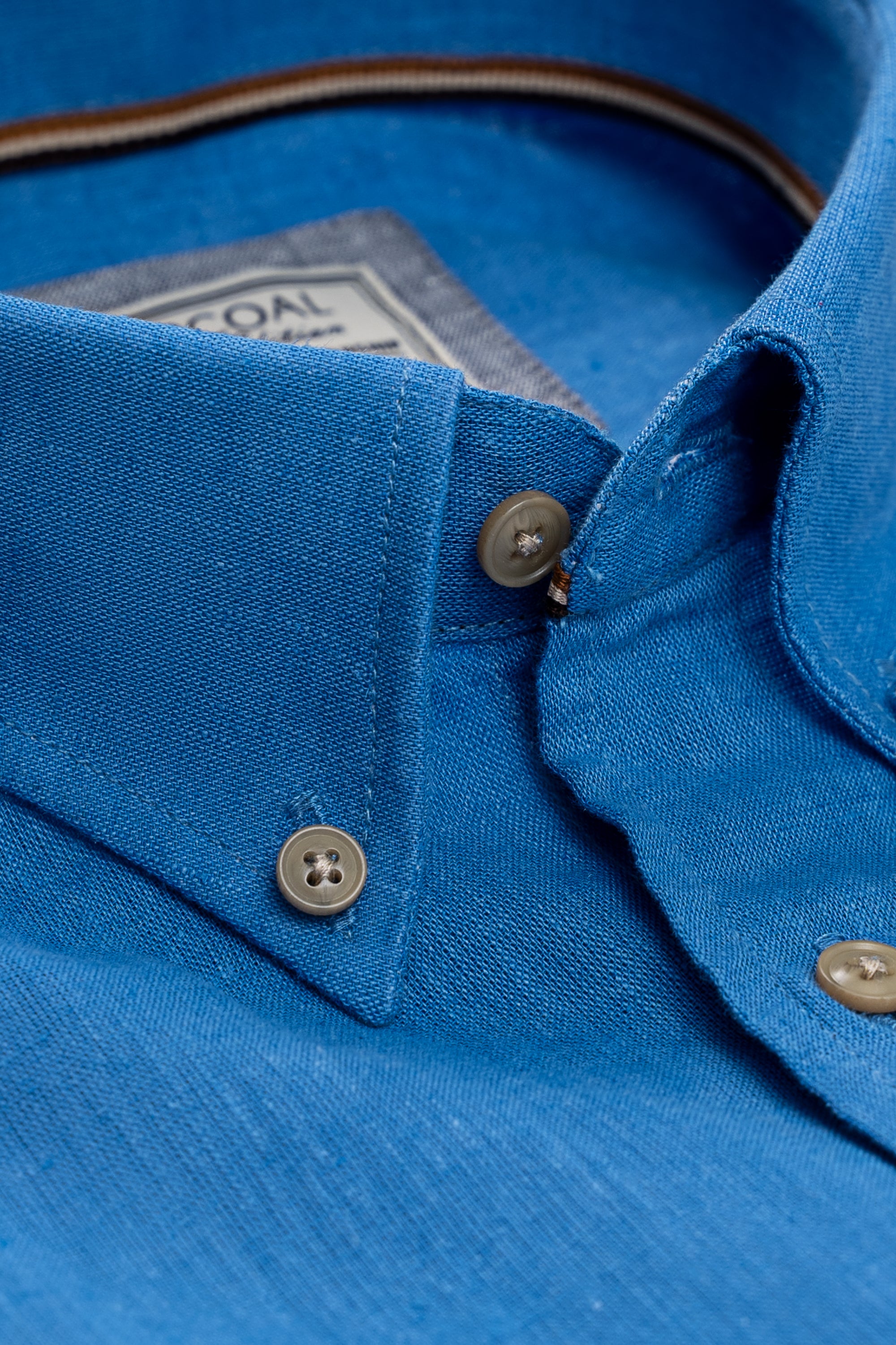 Blue linen shirt collar and button placket close-up