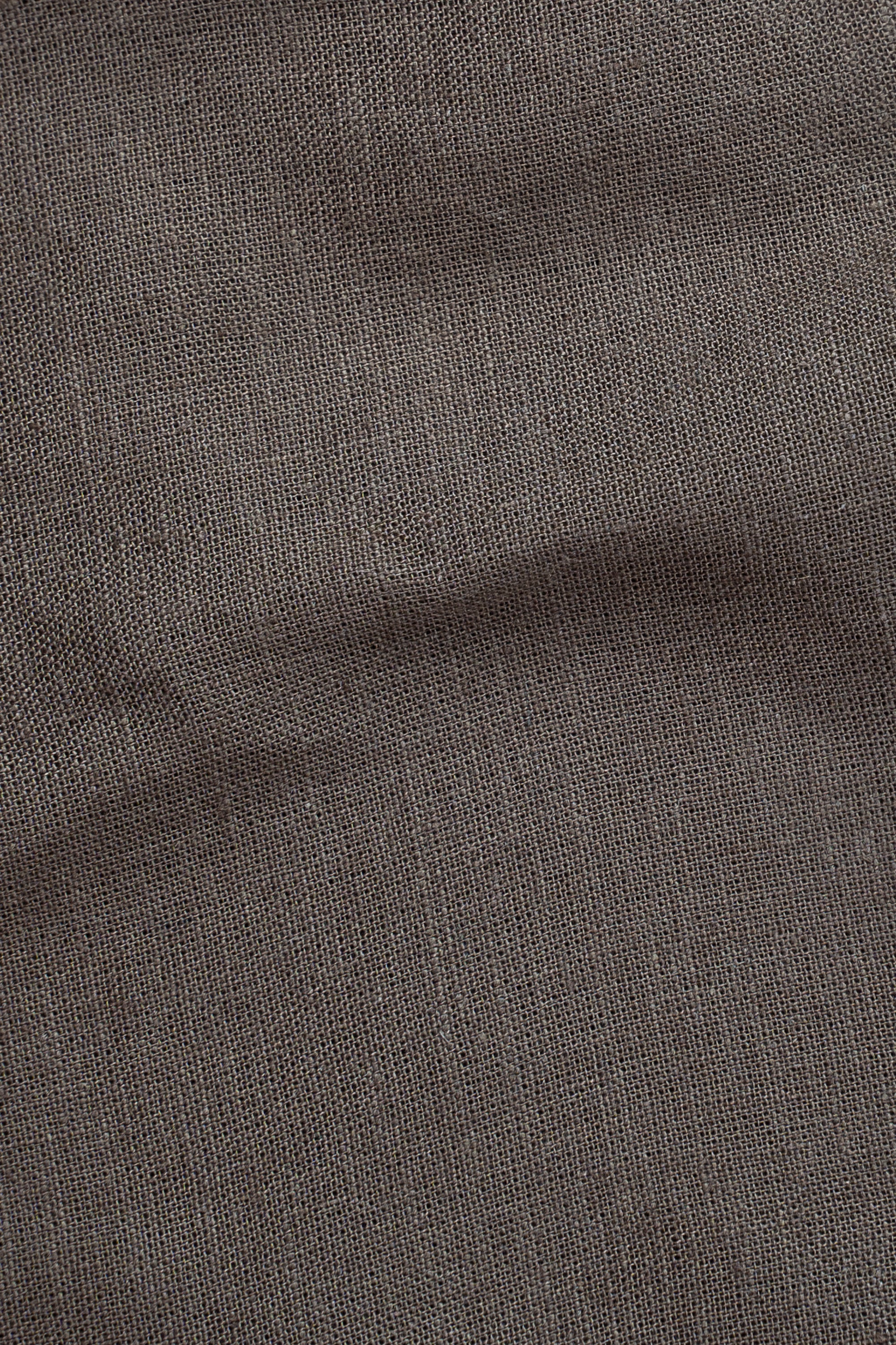 Brown linen fabric texture close-up with fine weave
