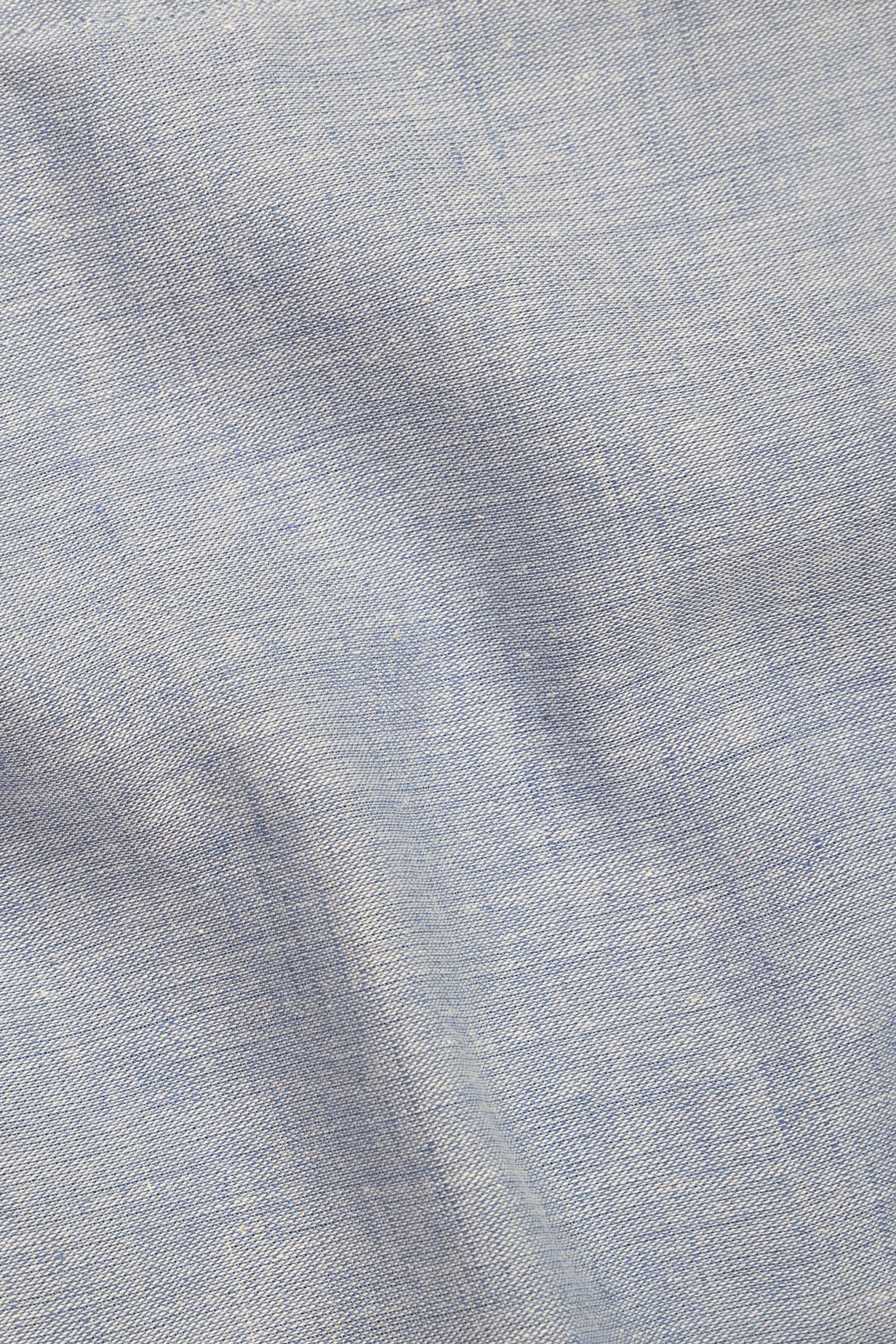 Sky blue linen fabric close-up with woven texture