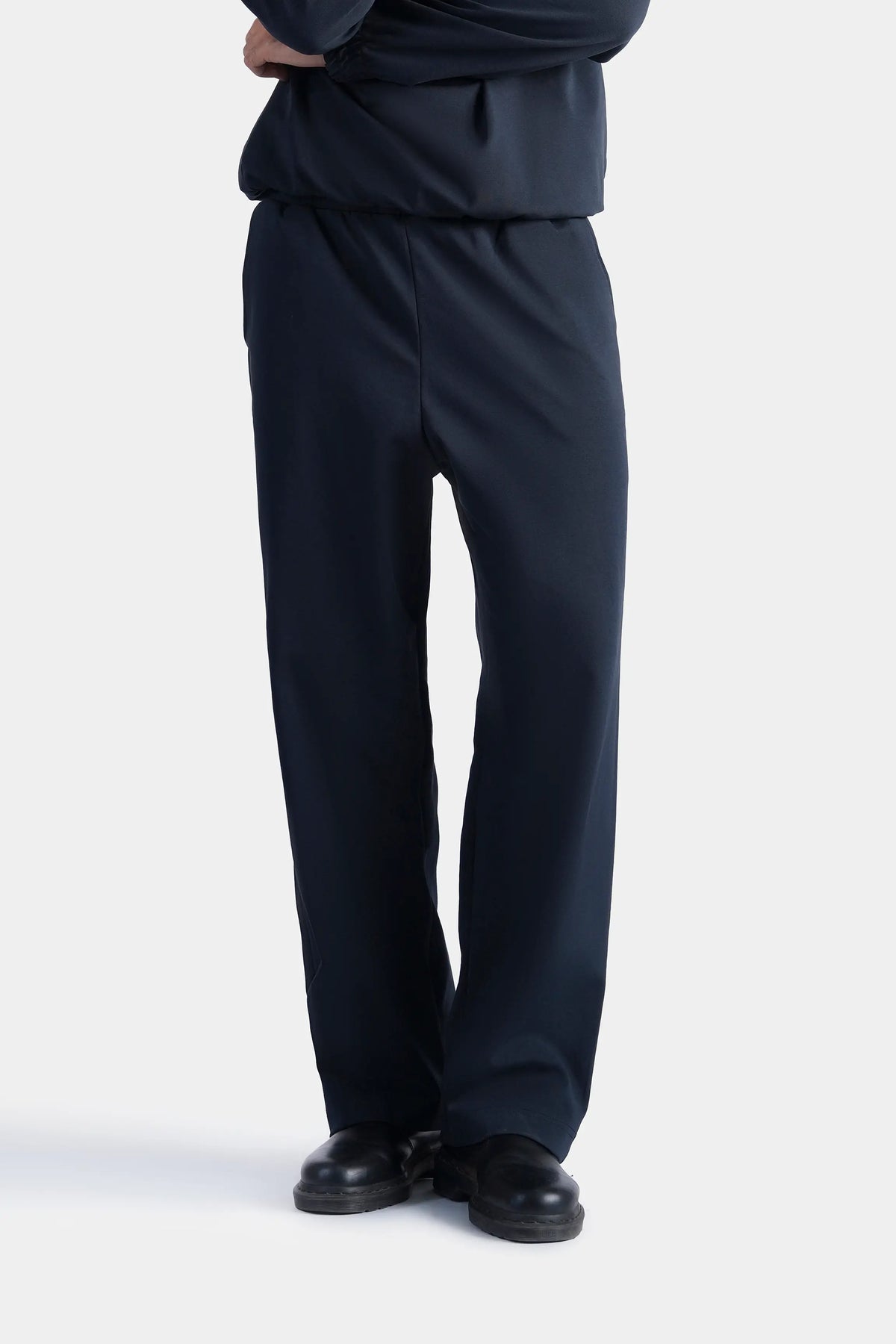 Navy scuba trousers with relaxed fit, straight legs, and elastic waist.