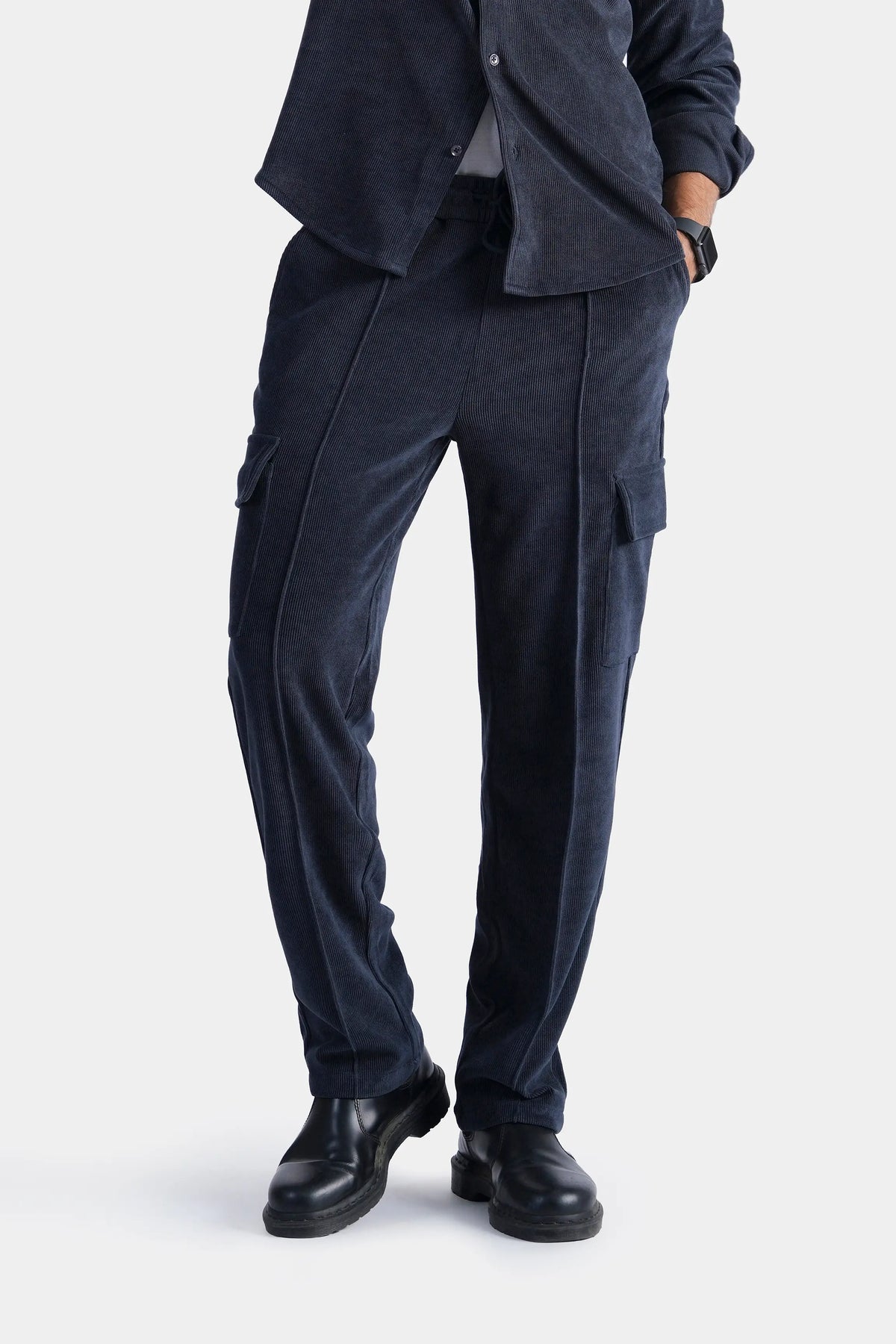 Navy corduroy cargo trousers with side flap pockets and cuffed hems