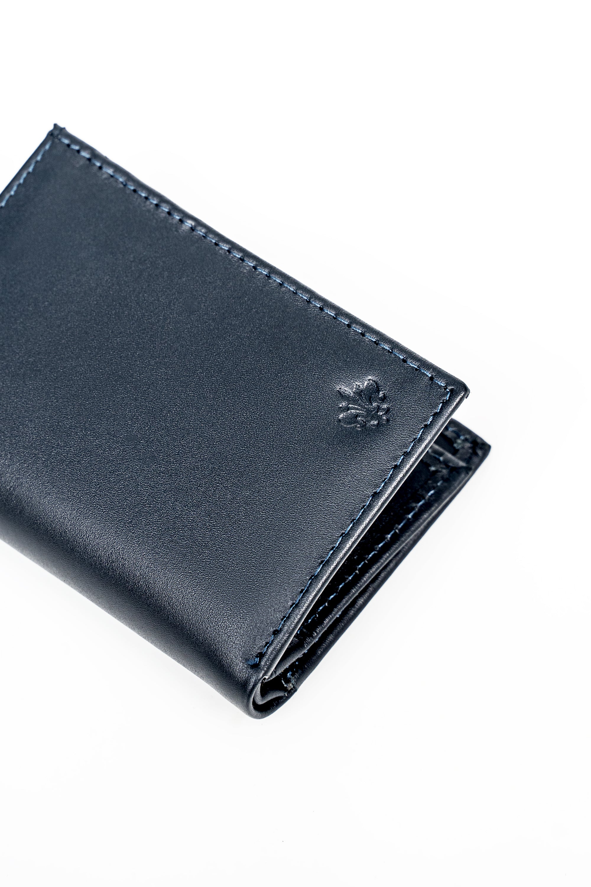 Blue folded wallet with snap closure and embossed floral emblem