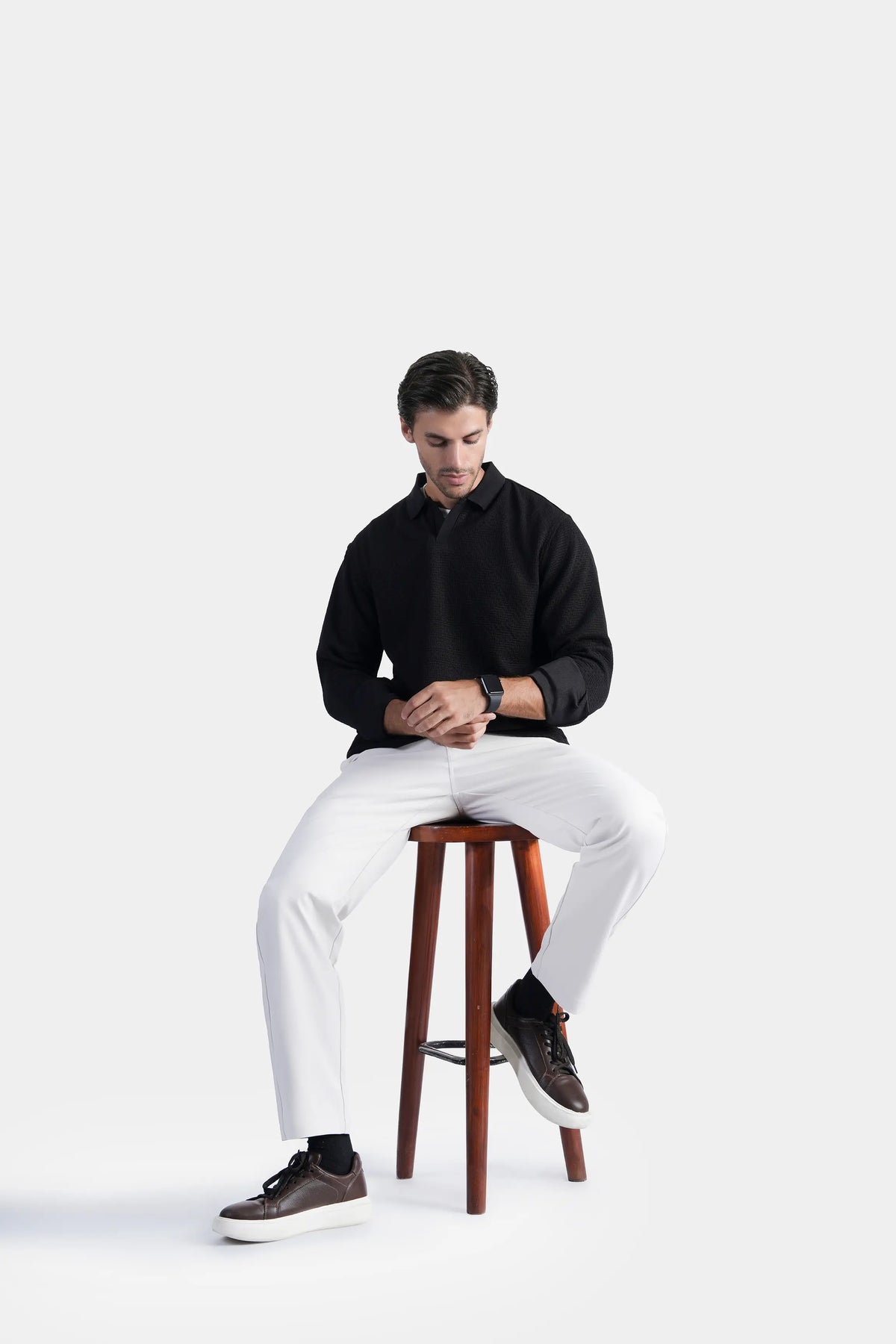 Black long-sleeve self-textured polo shirt, button front and raised collar detail