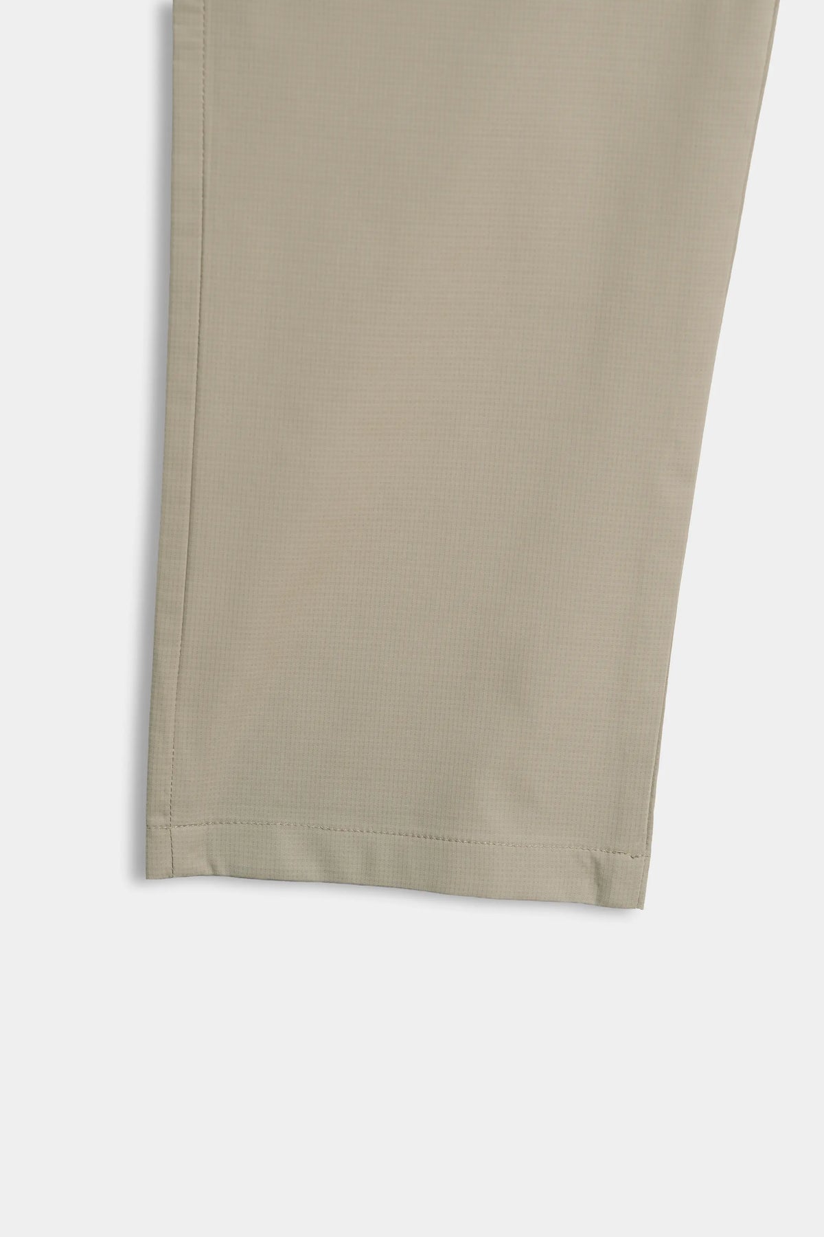 Beige casual trouser hem detail with clean stitched bottom edge