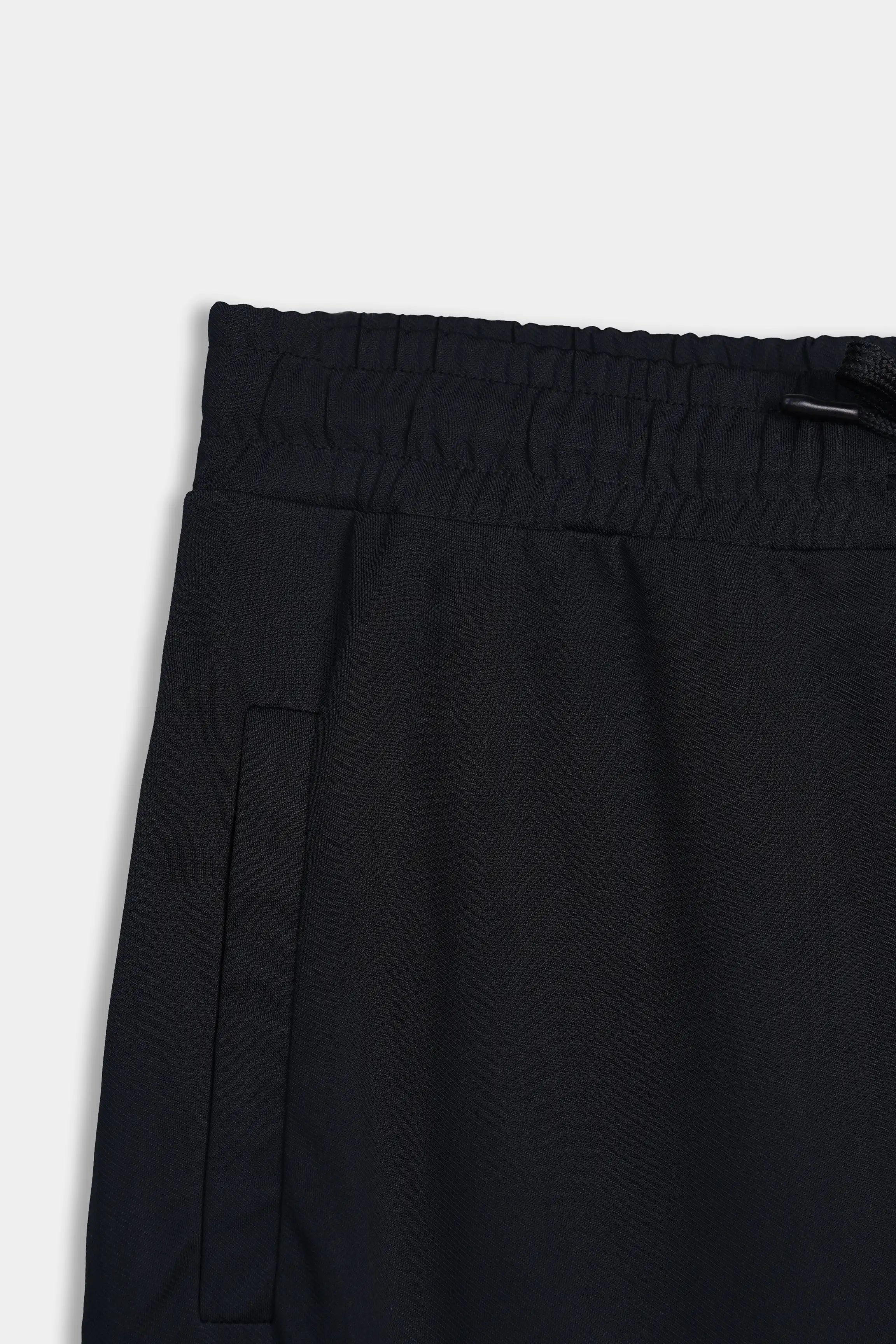 Black elasticated waistband trousers with front slash pocket opening detail