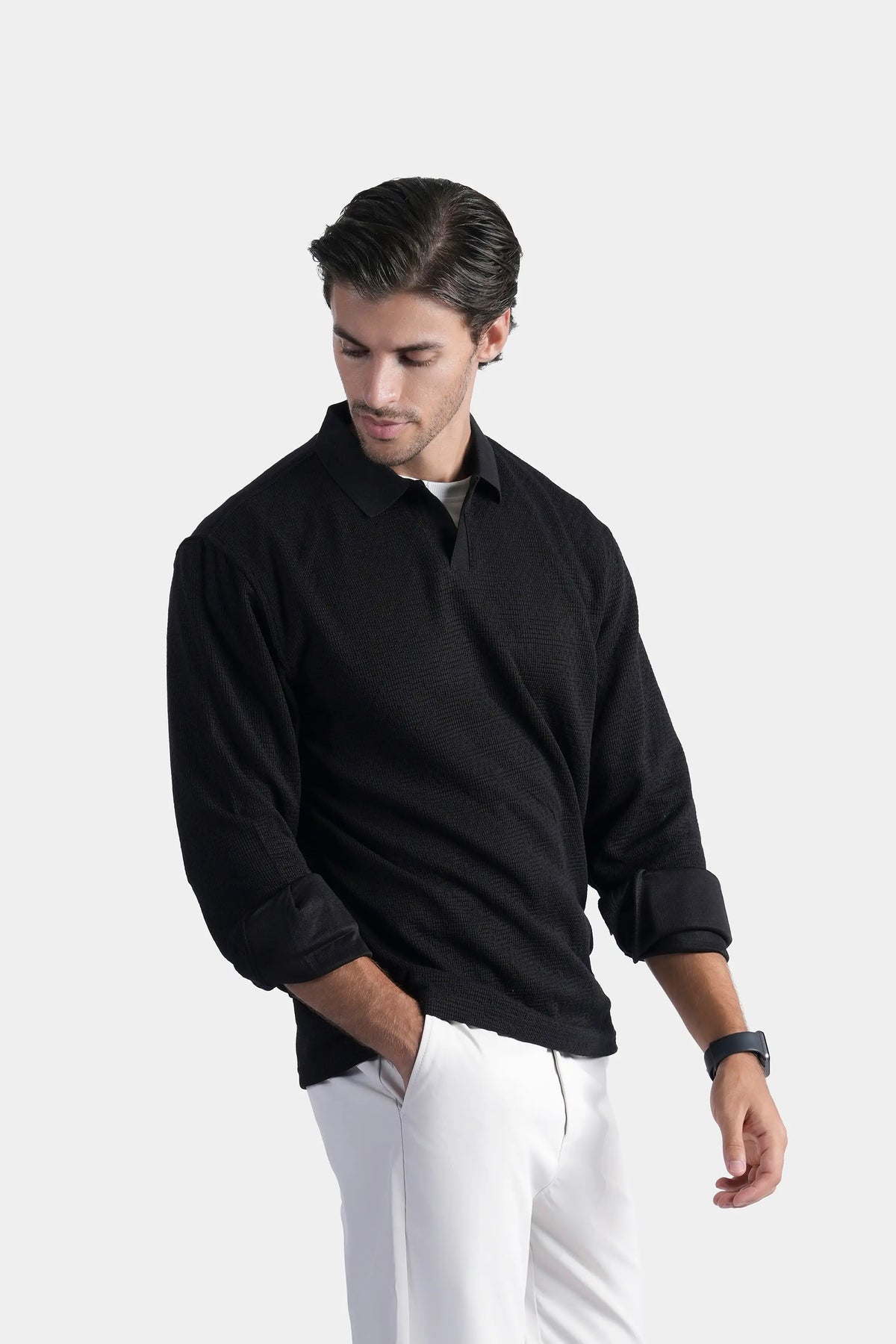 Black long-sleeve self-textured polo shirt with button front, folded collar, and cuffs