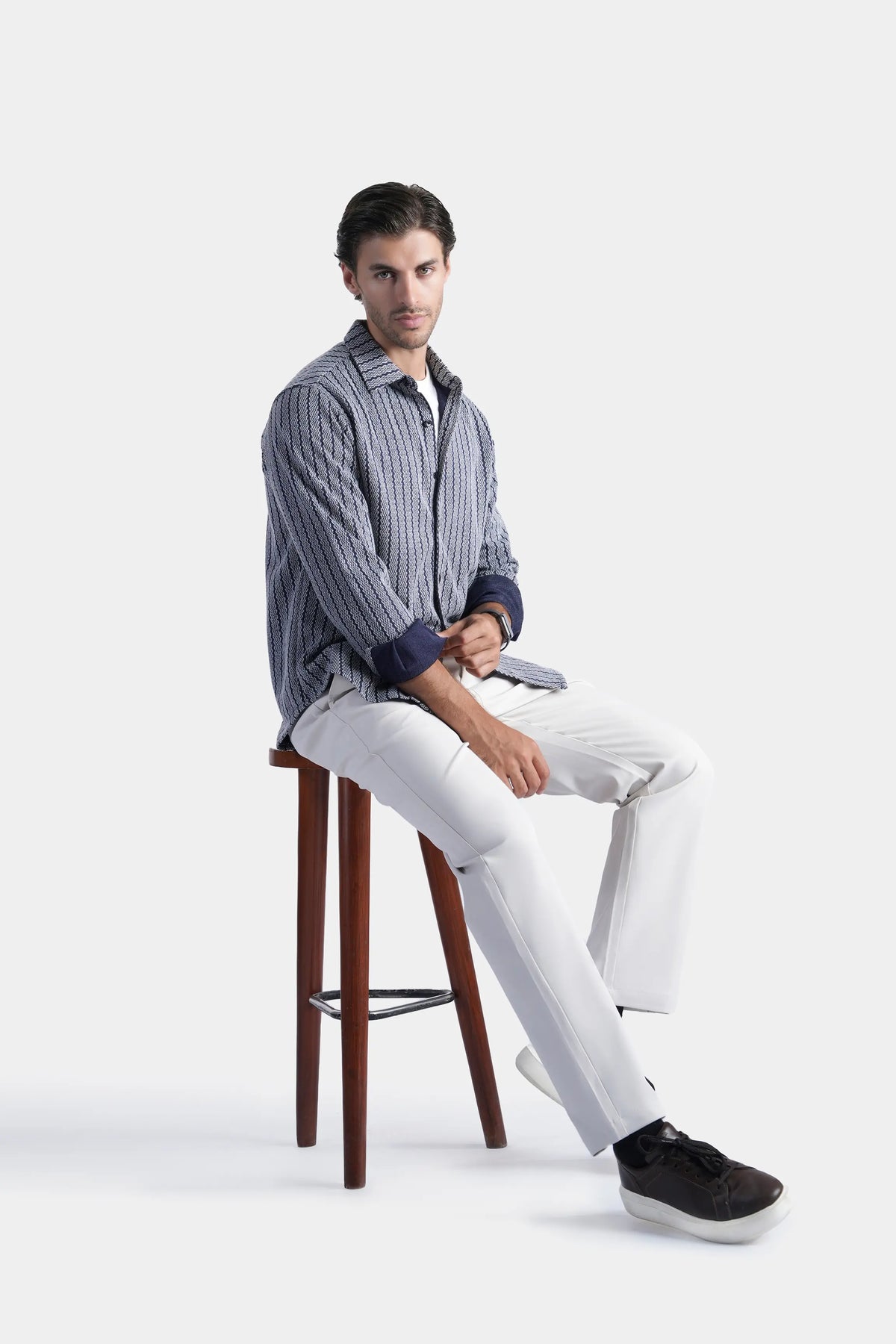Navy long-sleeve self-textured button-up shirt, seated front view with collar