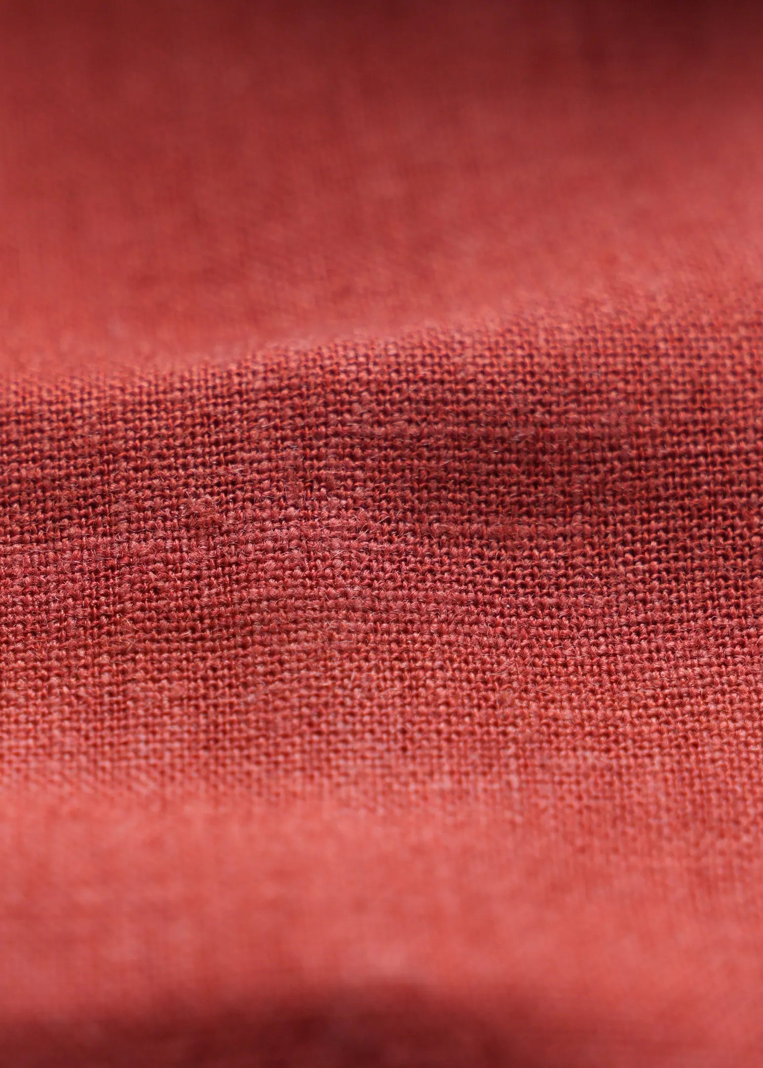 Tangerine linen fabric close-up showing breathable woven texture