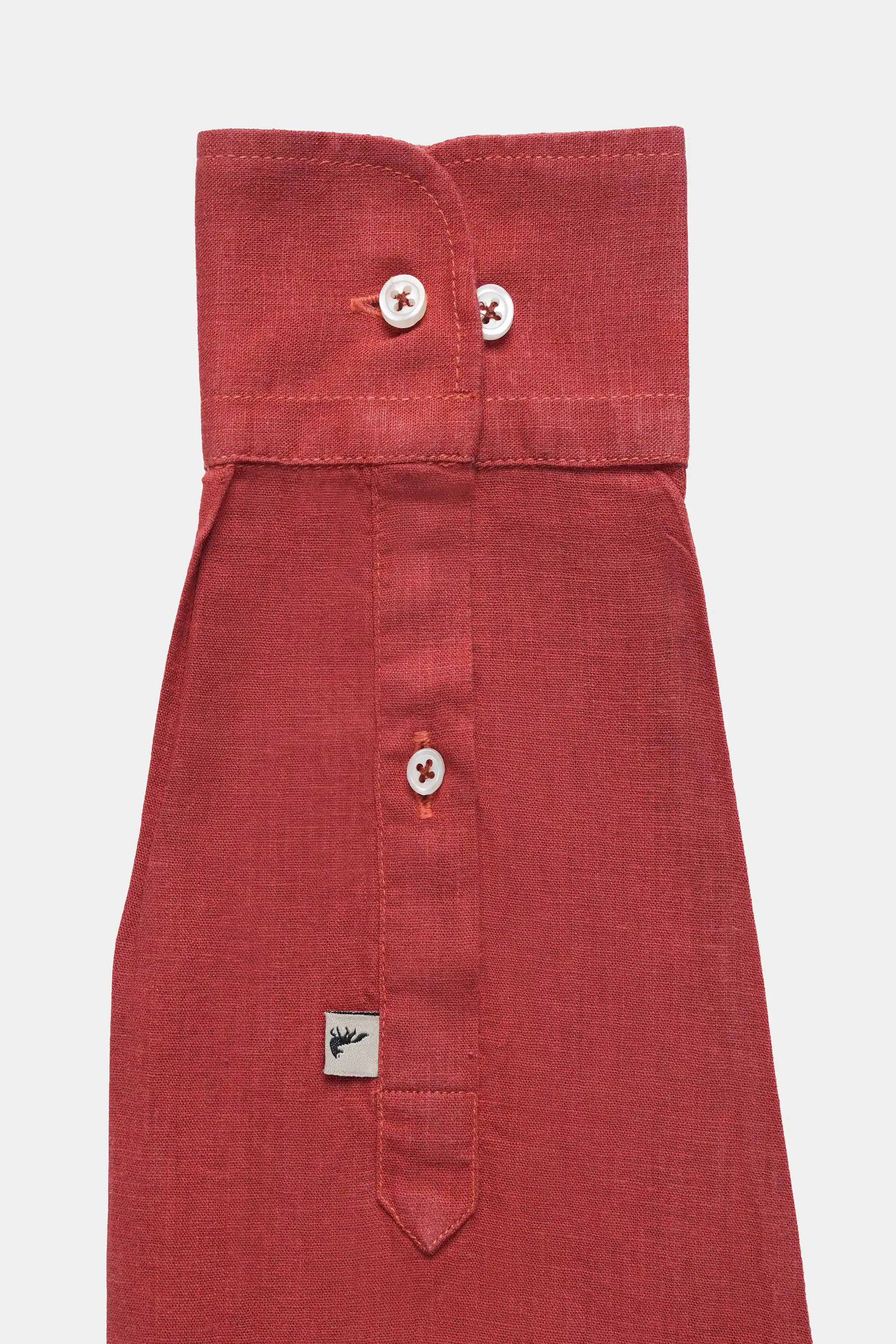 Tangerine linen shirt with fold-over collar, top buttons, and woven tag detail