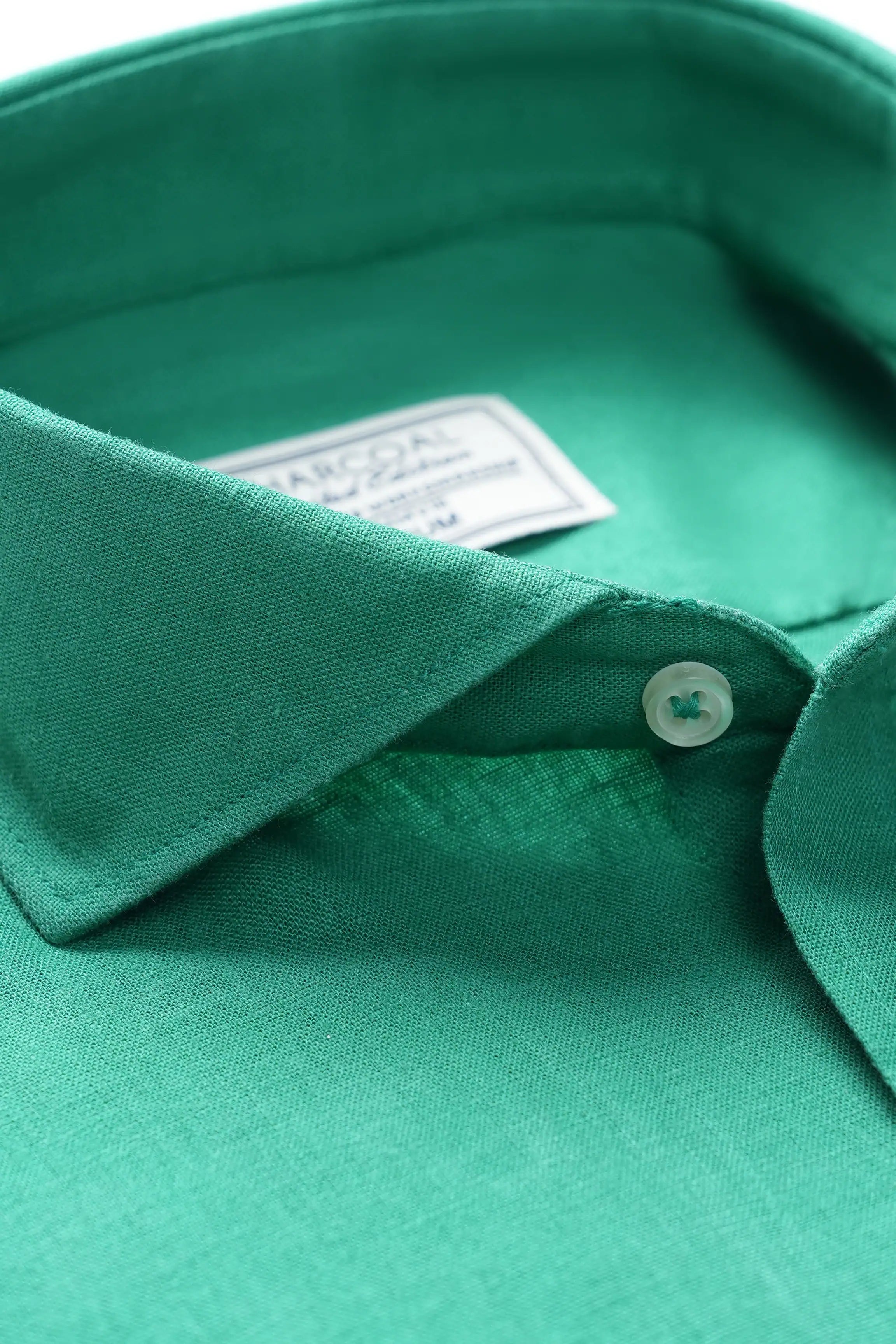 Green linen wide spread collar shirt closeup, buttoned placket and collar