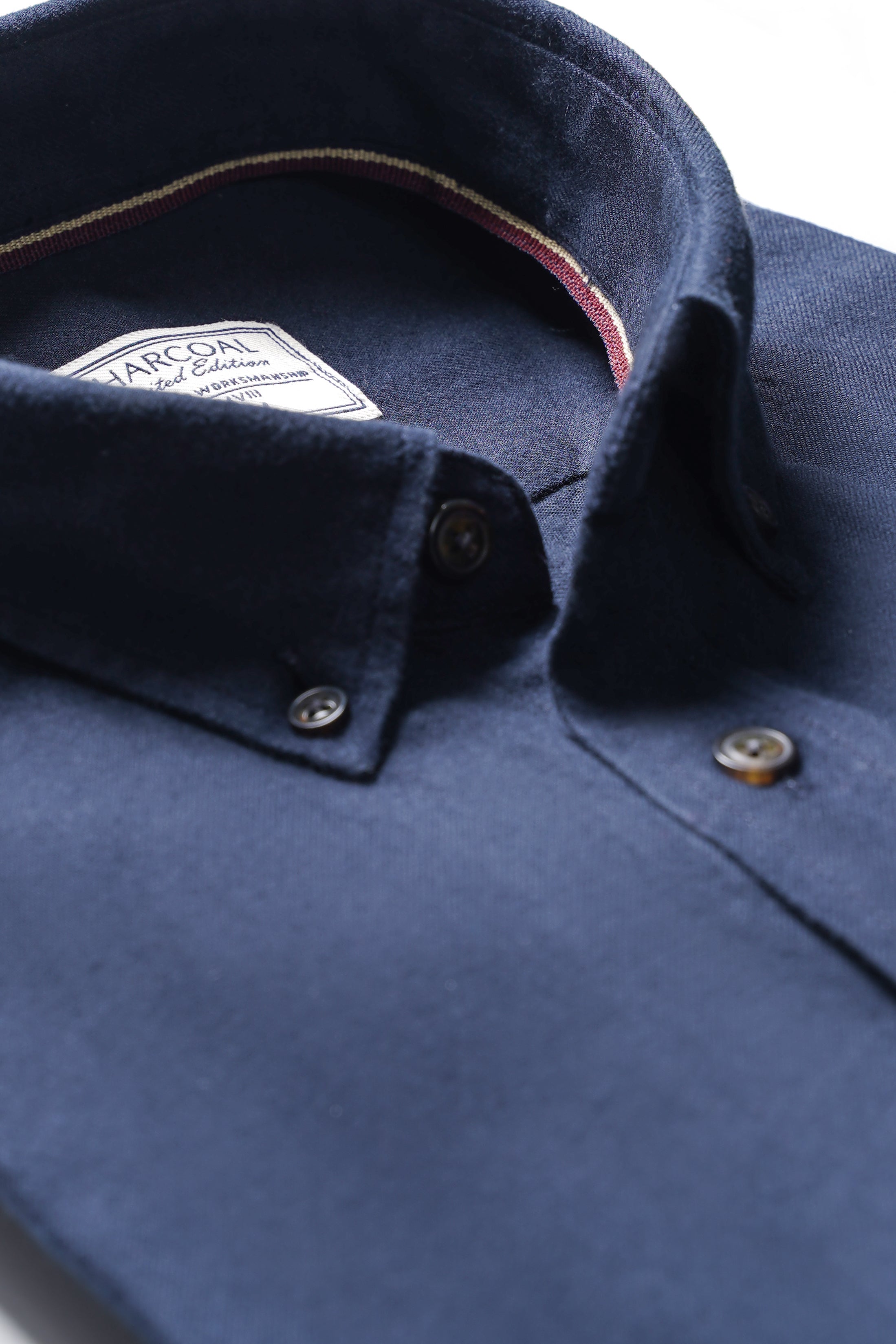 Woolen shirt close-up: dark blue button placket and collar label